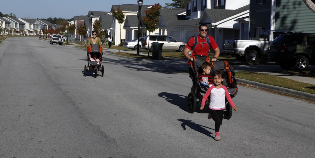 A Marine family wearing costumes prepares to run at the monthly family fun run on Tarawa Terrace aboard Marine Corps Base Camp Lejeune Oct. 20. Fun runs are a themed event and they give families and spouses time to be slightly silly while staying active through recreational fitness.