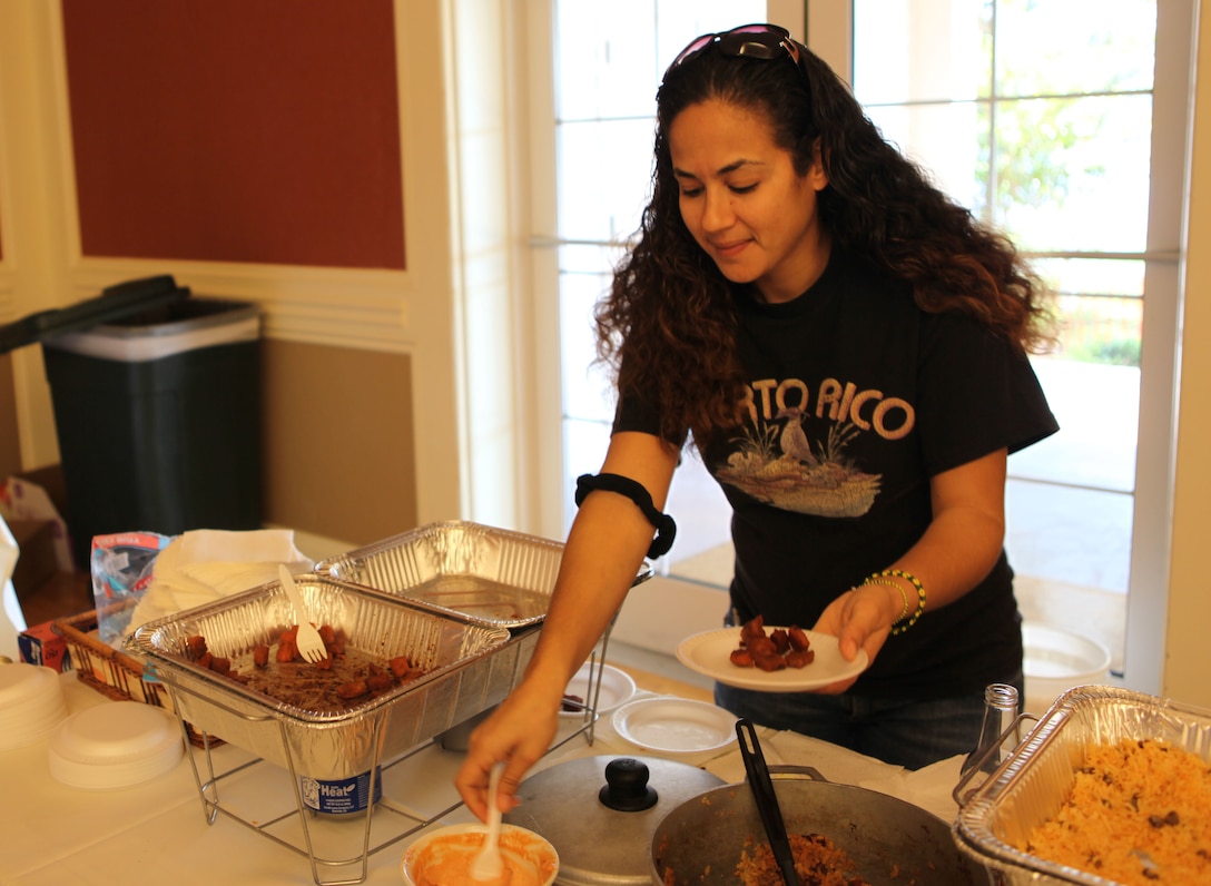 A participant of Marine Corps Base Camp Lejeune's Multi-Cultural Heritage Day serves some food from various cultures Oct. 24 at the Marston Pavilion. The event showcased cultures from around the world through displays, performances and food.