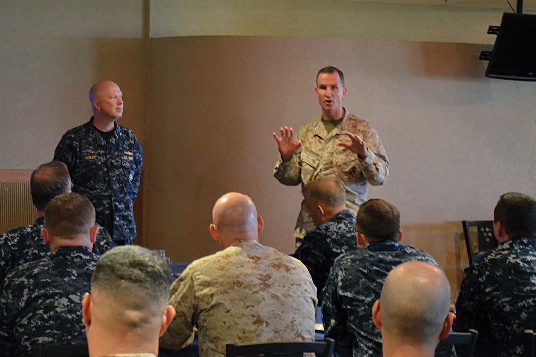Rear Adm. Jeffrey A. Harley and Col. John A. Ostrowski discuss joint integration and interoperability with members of Expeditionary Strike Group 7 and 3rd Marine Expeditionary Brigade at White Beach Nov. 2. Members of ESG 7 taught a class on the composite warfare commander concept and discussed joint interoperability and planning considerations for when the Navy and Marine Corps work together. The 3rd MEB is a scalable, middleweight force that a commander can tailor to efficiently meet the needs of a mission. Meetings like this improve Navy and Marine Corps interoperability and increase readiness and the ability to respond to a variety of crises and disasters while building professional and personal relationships between the two commands. Harley is the commander, ESG 7. Ostrowski is the chief of staff of 3rd MEB.