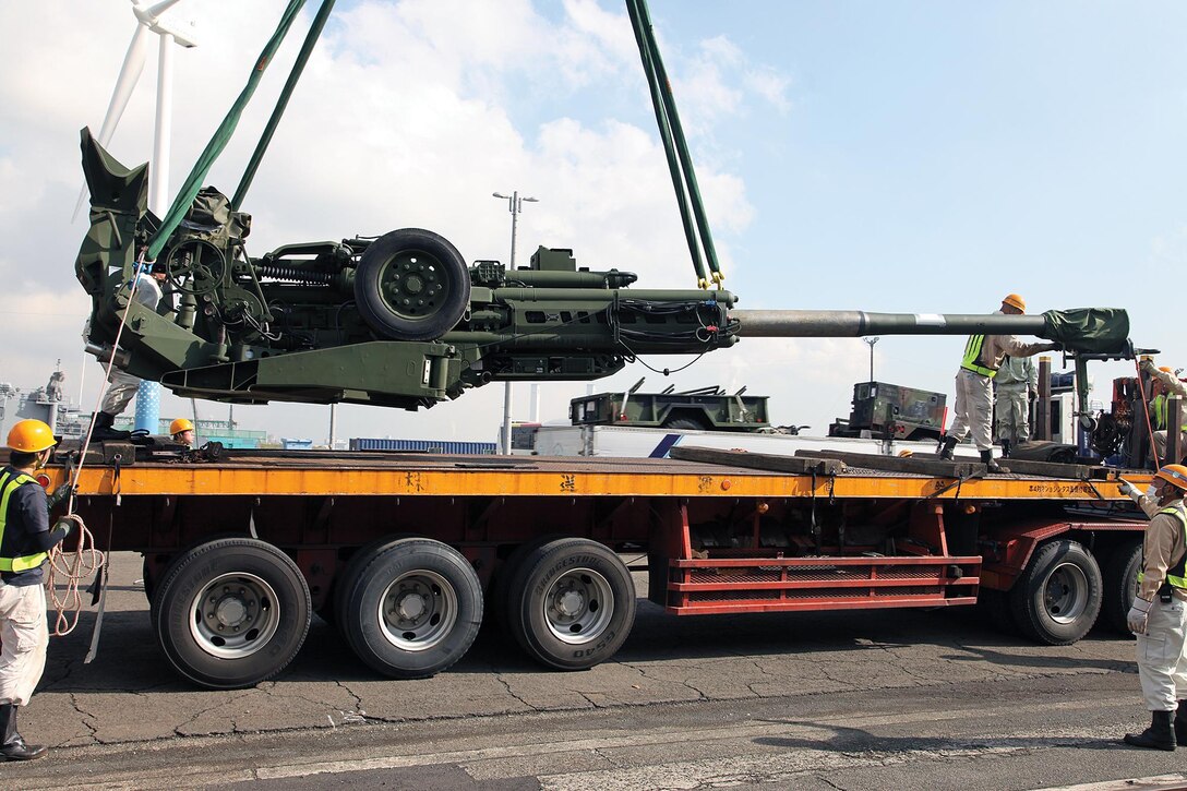 An M777A2 155 mm howitzer is loaded onto a trailer Nov. 7 at Yokohoma Port, Tokyo. Howitzers and other equipment were transported from the port to Combined Arms Training Center Camp Fuji for use during Artillery Relocation Training Program 12-3. 