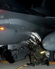 Airman Clifford Bould, 8th Aircraft Maintenance Squadron preps an F-16 Fighting Falcon for shutdown during exercise Beverly Bulldog 13-1 on Kunsan Air Base, Republic of Korea, Nov. 7, 2012. Bould dons  Mission Oriented Protective Posture gear in case the aircraft is contaminated. (U.S. Air Force photo/Senior Airman Marcus Morris)