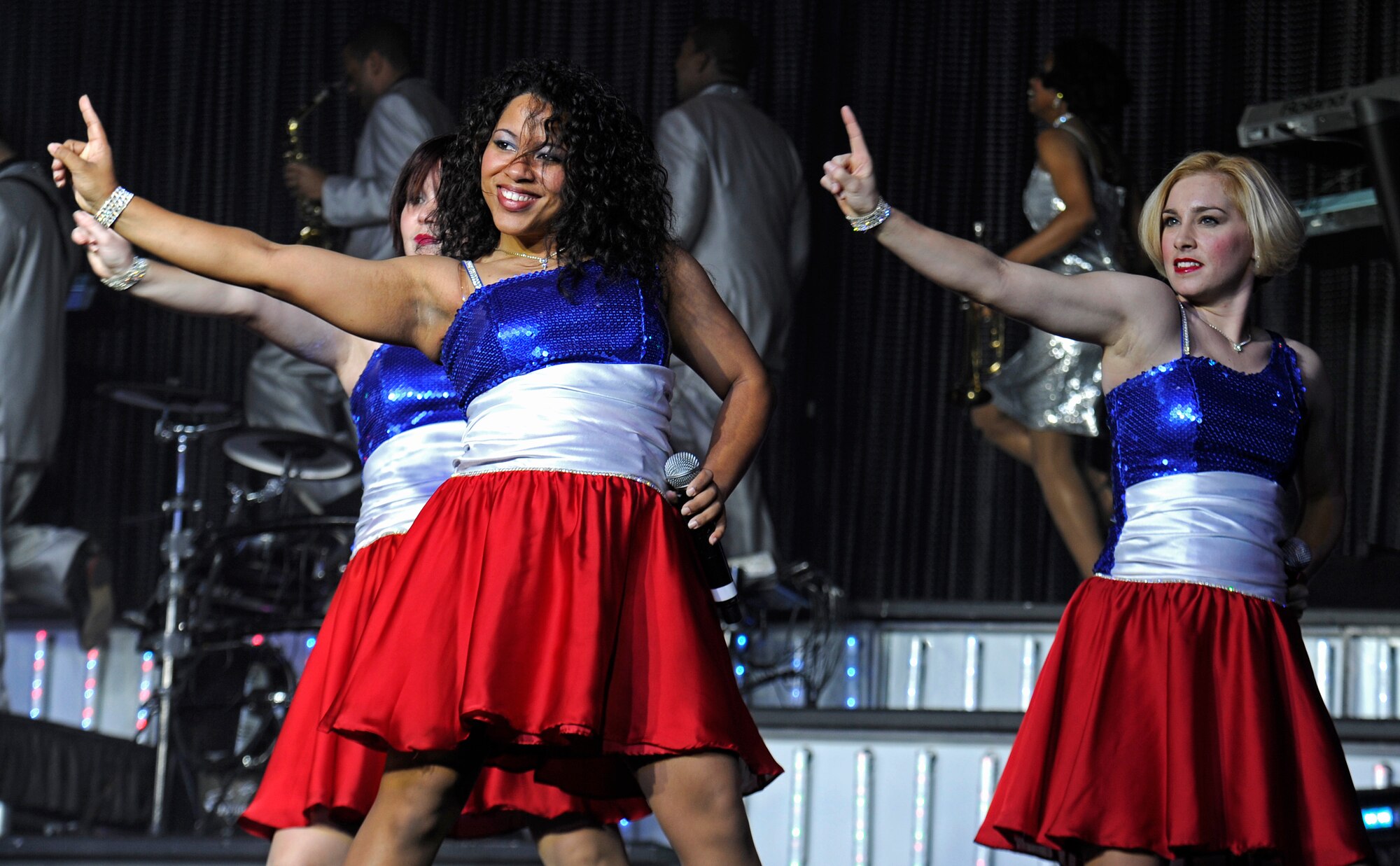 First Lt. Kandis Rich, 705th Combat Training Squadron acquisition officer, Senior Airman Briana Hofreiter, 15th Comptroller Squadron financial management and comptroller apprentice, and Senior Airman Kerrilee Meeker, Air Force Technical Applications Center technical applications specialist, entertain the audience during the Tops in Blue 2012 World Tour show at the Northern Quest Casino and Resort in Airway Heights, Wash., Nov. 6, 2012. Made up of 31 active duty vocalists, dancers and musicians, they perform an average of 150 times a year, stopping at more than 100 locations around the world. (U.S. Air Force photo by Airman 1st Class Ryan Zeski)