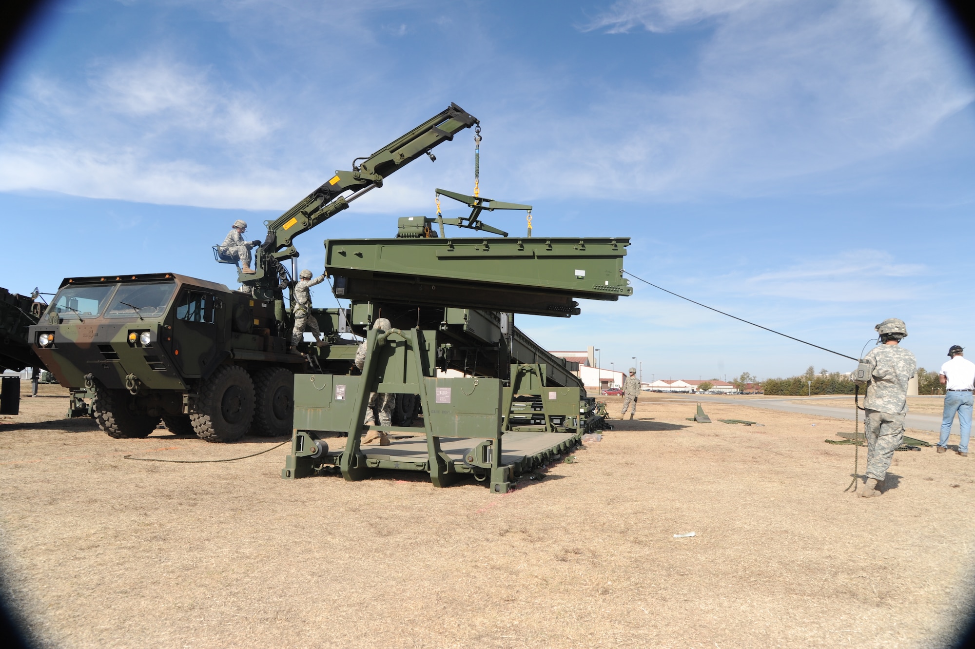 Soldiers with the 401st Engineer Company, Detachment 1, prepare to place a ramp module for a Dry Support Bridge during new equipment training Nov. 2 behind the Armed Forces Reserve Center at Vance Air Force Base, Okla. (U.S. Air Force photo/ Airman 1st Class Frank Casciotta)