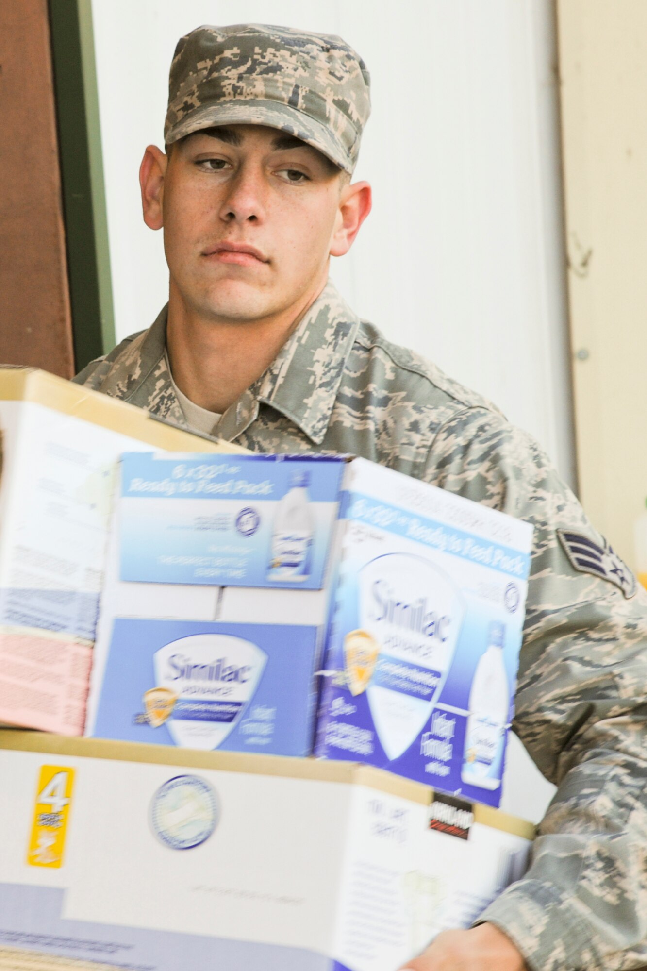 LINFORD, N.J. -- U.S. Air Force Senior Airman Kent Cross carries boxes of baby formula at the Thompson Park Community Center in Monmouth County, N.J., Nov. 6. Cross, a native of Long Island, N.Y., assigned to the 305th Maintenance Squadron at Joint Base McGuire-Dix-Lakehurst, N.J., joined members of the base honor guard to assist in collection efforts to aid Monmouth County residents impacted by Hurricane Sandy. (U.S. Air Force photo by Tech. Sgt. Zachary Wilson/Released)