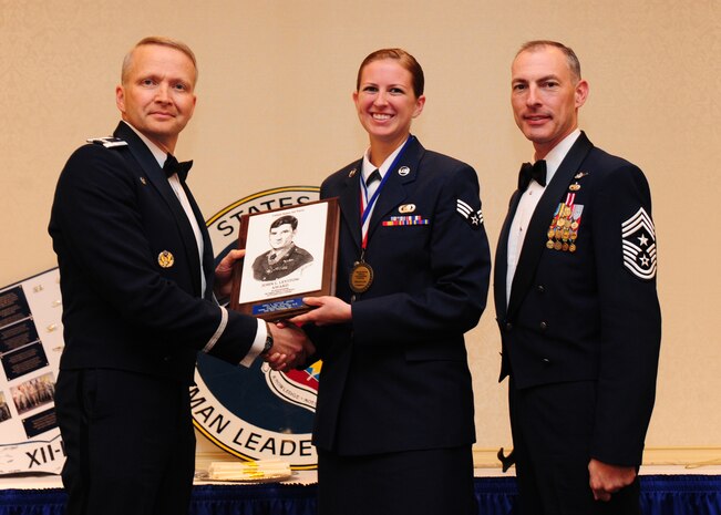 Col. Darren Hartford, 437th Airlift Wing commander and Chief Master Sgt. Larry Williams, 437th AW command chief, present Senior Airman Keitha McCarthy, 437th Operations Group intelligence analyst, the John L. Levitow Award during the Airman Leadership School Class 2012-H graduation ceremony Nov. 1, 2012, at JB Charleston - Air Base, S.C. The Levitow Award is awarded for a student's exemplary demonstration of excellence, both as a leader and scholar. (U.S. Air Force photo/Staff Sgt. Katie Gieratz)