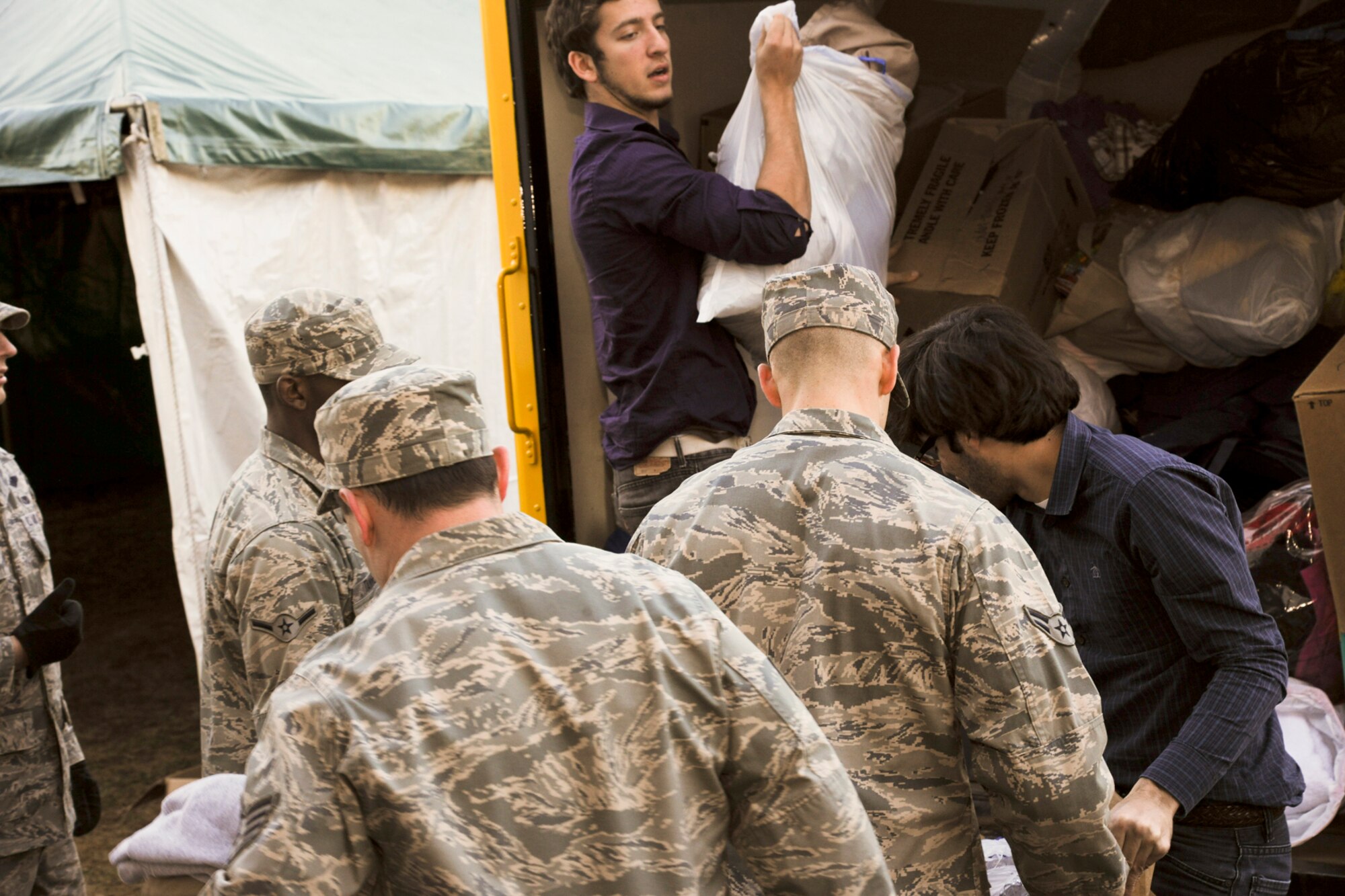 LINFORD, N.J. -- U.S. Air Force Airmen from Joint Base McGuire-Dix-Lakehurst, N.J., unload a delivery truck carrying aid supplies at Thompson Park Community Center in Monmouth County, N.J., intended for residents impacted by Hurricane Sandy. Nearly a dozen Airmen joined county volunteers to unload 18 truckloads of aid benefitting hundreds of people left without power in the county. (U.S. Air Force photo by Tech. Sgt. Zachary Wilson/Released)