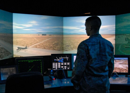 Airman 1st Class Cote Werner, 412th Operations Support Squadron, trains using the ADACEL control tower simulator, which combines voice recognition software with a photo-realistic view of the Edwards airfield. Edwards has been using the simulator to train air traffic control personnel since 2005. (U.S. Air Force photo/Laura Mowry) 

