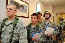 U.S. Air Force Airmen assigned to the 4th Fighter Wing wait to process through the Personnel Deployment Facility during Operational Readiness Exercise Coronet Warrior 12-05 on Seymour Johnson Air Force Base, N.C., Nov. 5, 2012. When processing through the PDF line, a personnel apprentice inspects each Airman’s training records and mobility bags to ensure they are ready to deploy. (U.S. Air Force photo/Airman 1st Class Aubrey White/Released)