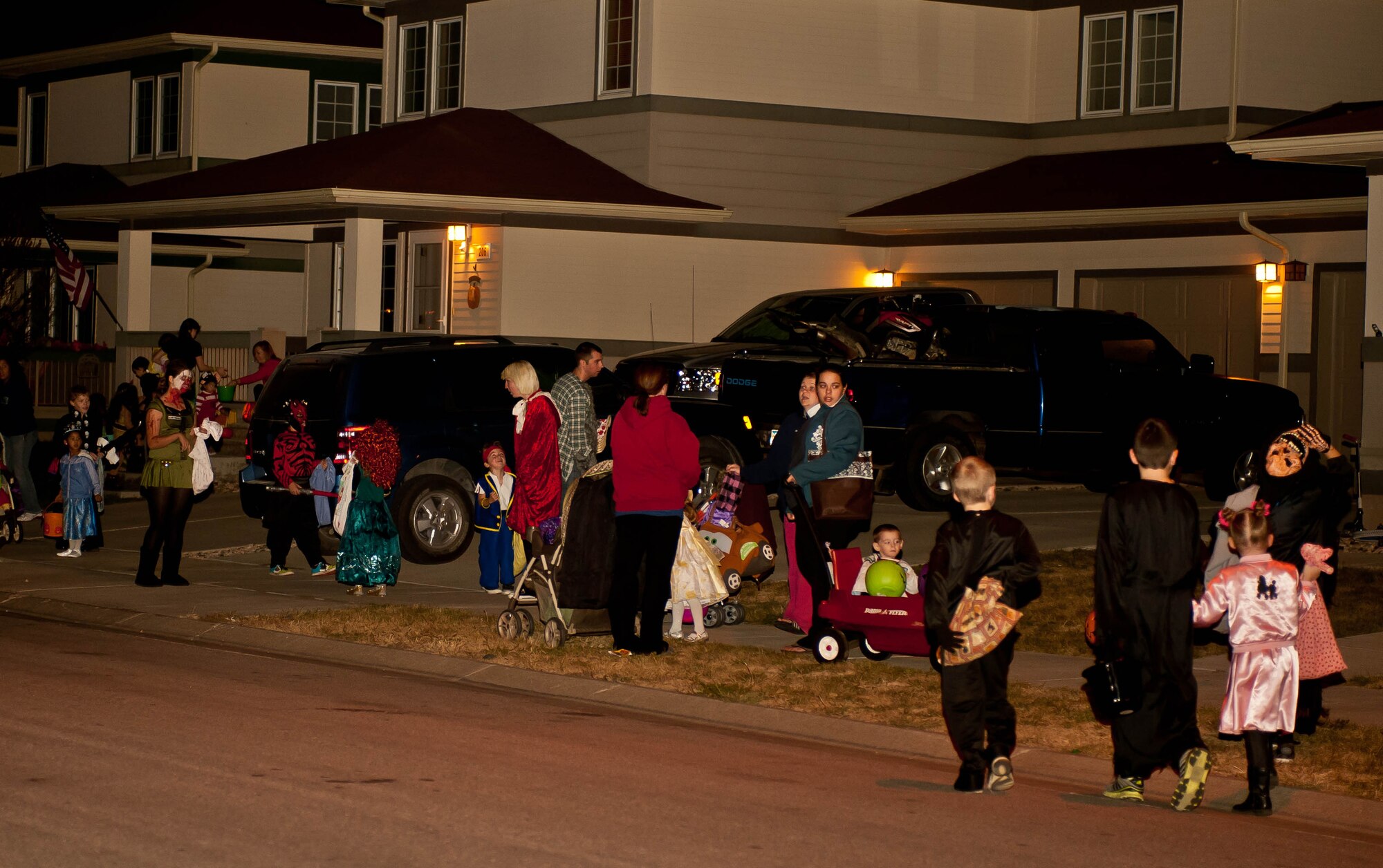 Youths of all ages sporting a variety of costumes filled the streets during Halloween at Ellsworth Air Force Base, S.D., Oct. 31, 2012. Volunteers from a variety of organizations teamed up to ensure the safety of children and their families as they went door-to-door throughout the evening. (U.S. Air Force photo by Airman 1st Class Zachary Hada/Released)
