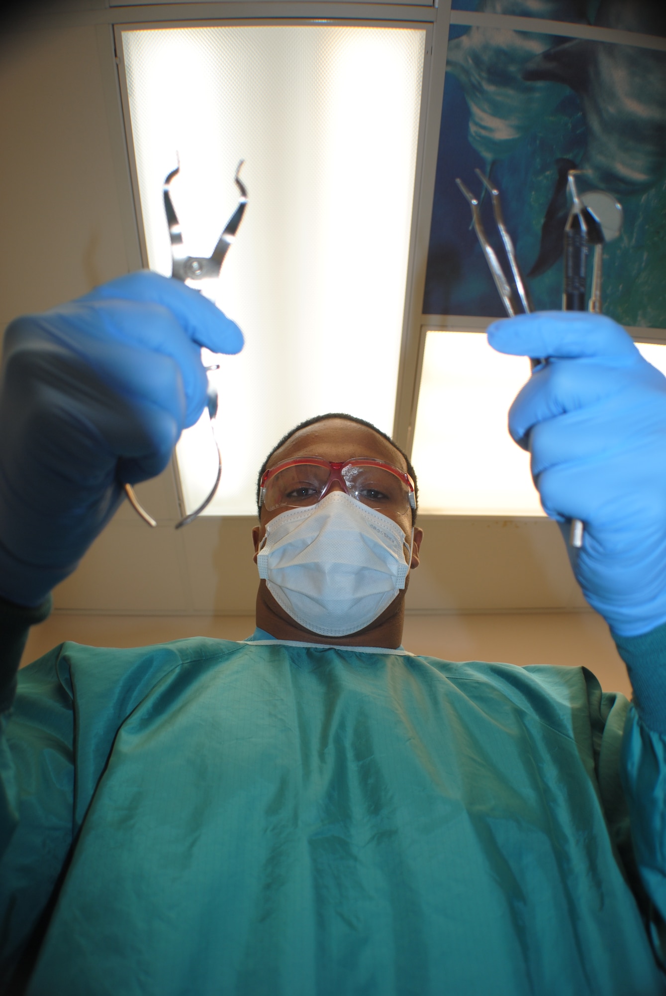 Airman 1st Class Robin Reese, prepares an aluminum rack of dental tools prior to a patient’s arrival Nov. 6, 2012, at the dental clinic on Grand Forks Air Force Base N.D. Reese, a dental assistant with 319th Medical Operations Squadron, said the surgical mask around his mouth is worn in order to prevent the sterilized equipment from human contamination caused by sneezing or coughing. (U.S. Air Force photo/Senior Airman Luis Loza Gutierrez)