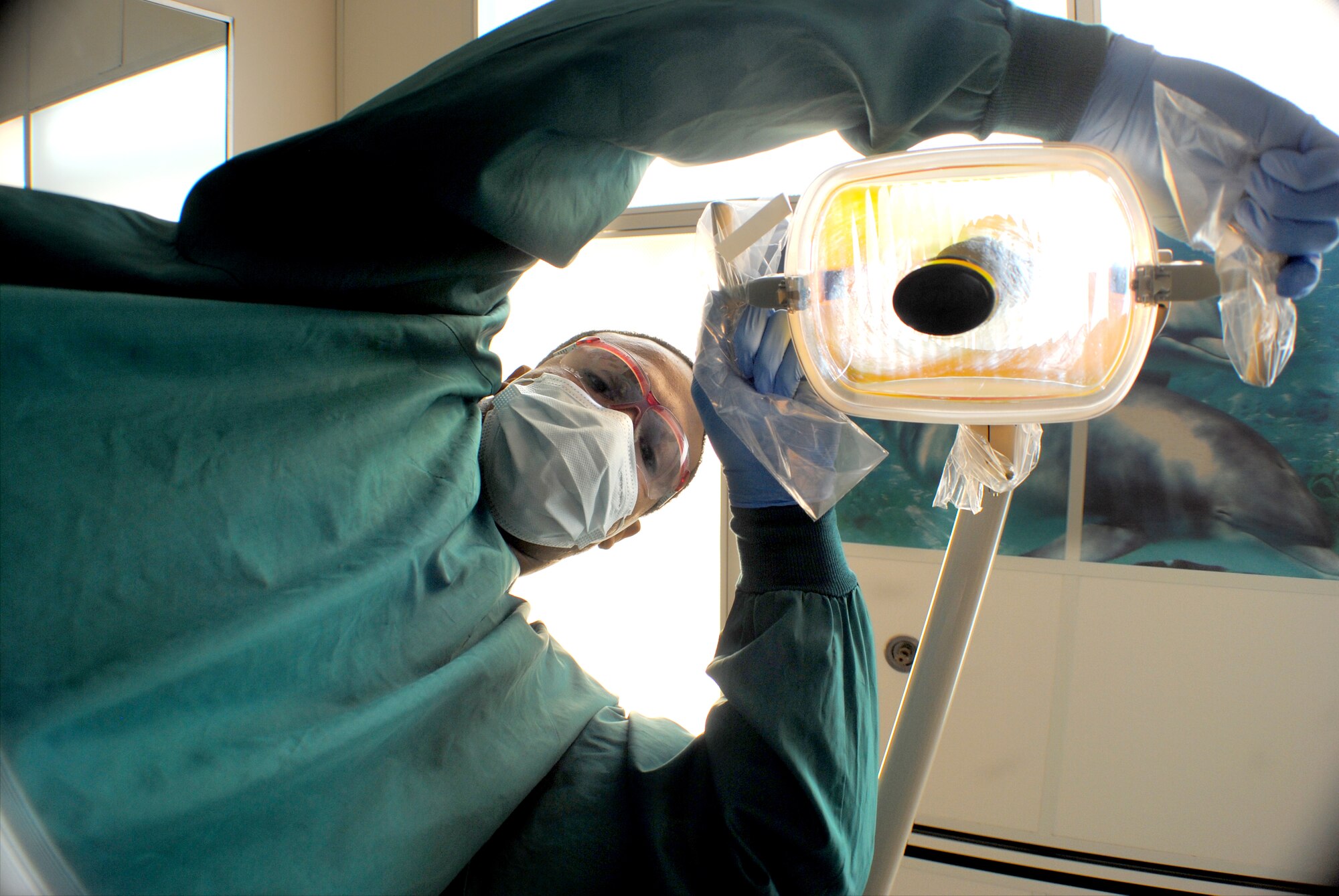 Airman 1st Class Robin Reese, a 319th Medical Operations Squadron dental assistant, adjusts the dental chair light so it properly illuminates a patient’s mouth during a routine dental check up, Nov. 6, 2012, on Grand Forks Air Force Base, N.D. Reese assists with approximately 50 to 80 dental procedures per month. As a dental assistant, Reese assists doctors in specialty areas such as oral surgery, periodontics (treatment of gum disease), prosthodontics (replacement of missing teeth) and endodontics (root canal treatment). He also takes, develops and mounts dental X-rays. (U.S. Air Force photo/Senior Airman Luis Loza Gutierrez)