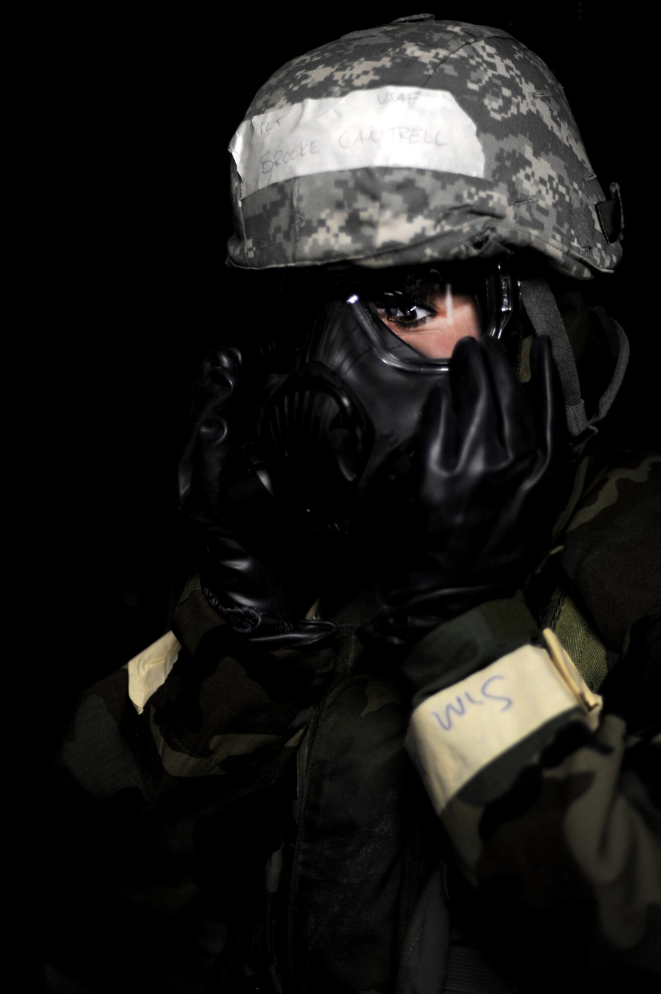 U.S. Air Force 1st Lt. Brooke Cantrell, 354th Maintenance Squadron flight officer in charge, checks for a proper seal on her M-50 protective mask during an operational readiness exercise Nov. 6, 2012, Eielson Air Force Base, Alaska. The M-50 protective mask can provide up to 24 hours of continuous respiratory protection in nuclear, biological and chemical environments. (U.S. Air Force photo/Staff Sgt. Jim Araos)