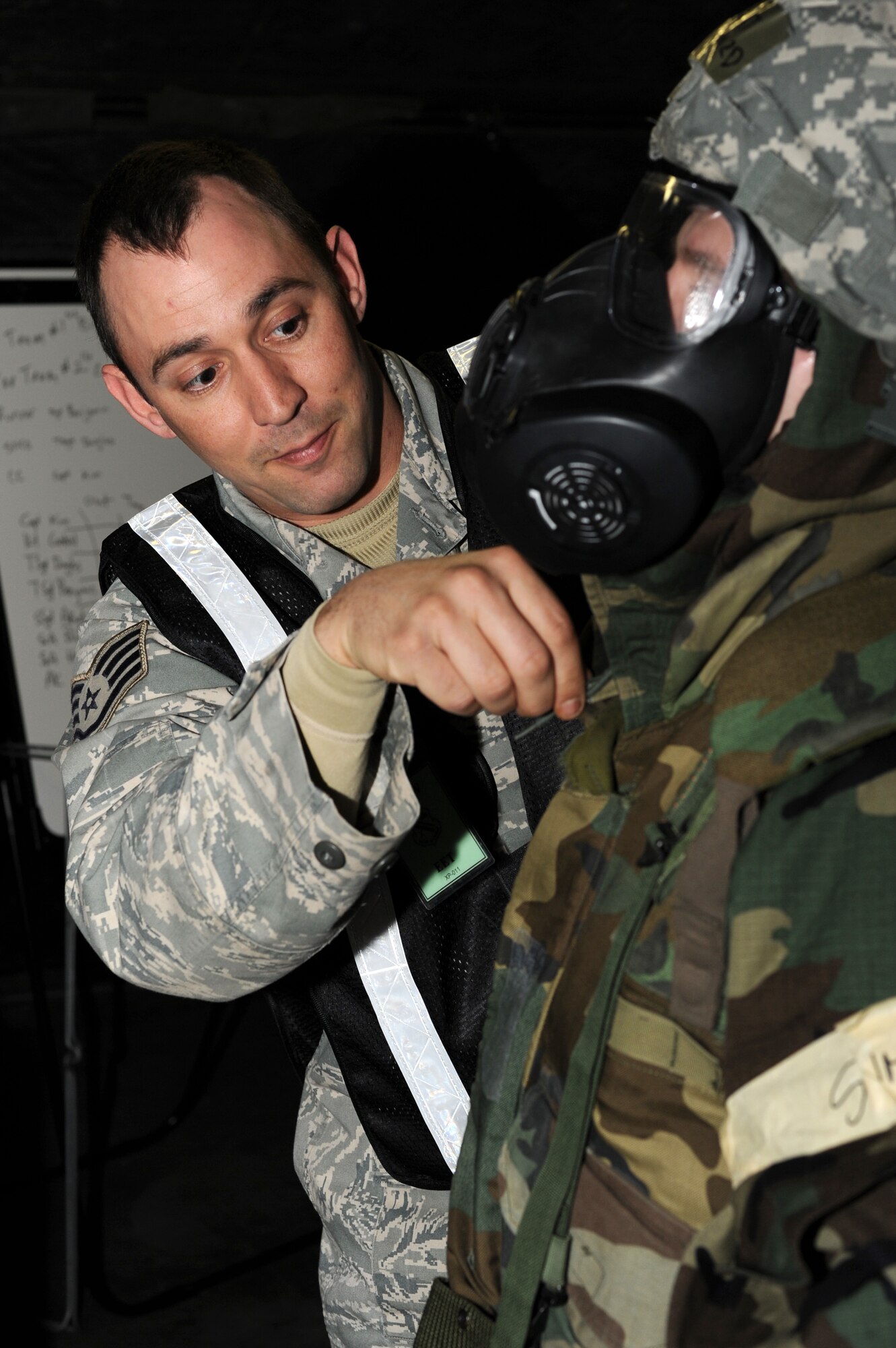 U.S. Air Force Staff Sgt. William Walker, 354th Civil Engineer Squadron pavement and equipment craftsman, checks the seals on protective masks during an operational readiness exercise Nov. 6, 2012, Eielson Air Force Base, Alaska. As an exercise evaluation team member, Walker creates a realistic exercise scenario to enhance the training environment for Icemen. (U.S. Air Force photo/Staff Sgt. Jim Araos)