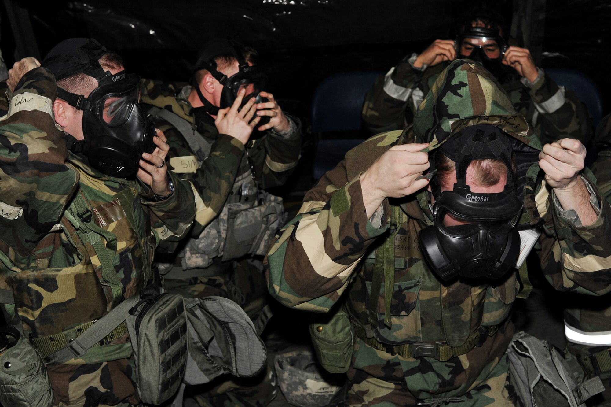 Icemen assigned to the 354th Fighting Wing don M-50 protective masks during an operational readiness exercise Nov. 6, 2012, Eielson Air Force Base, Alaska. During the ORE, Icemen reacted to simulate improvised explosive devices and chemical attacks, security breaches, mass casualties and building fires. (U.S. Air Force photo/Staff Sgt. Jim Araos)