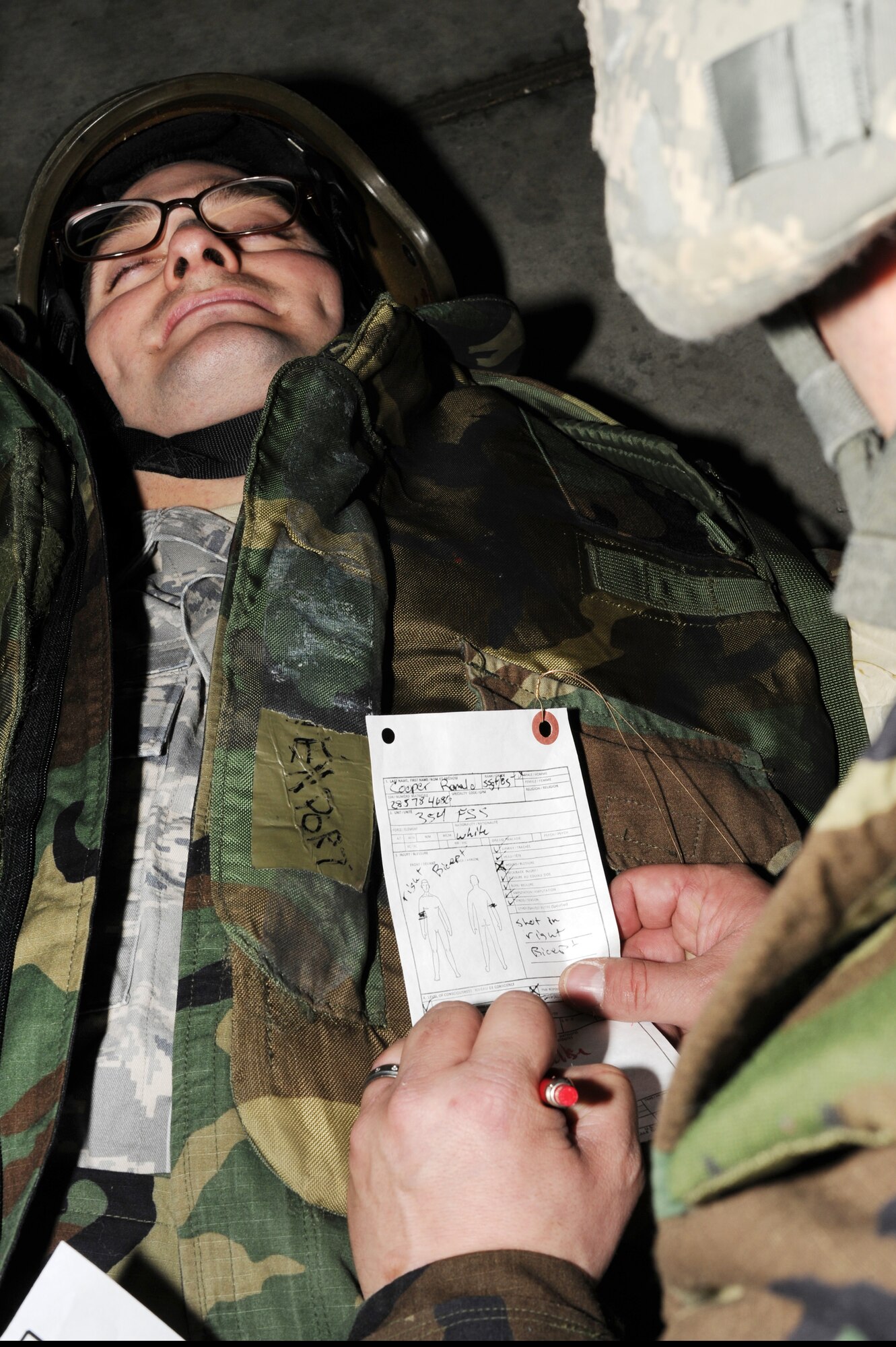 U.S. Air Force Staff Sgt. Timothy Raso, 354th Medical Operation Squadron independent duty medical technician, fills out a field medical card for Staff Sgt. Ronald Cooper, 354th Force Support Squadron kitchen manager, during an operational readiness exercise Nov. 6, 2012, Eielson Air Force Base, Alaska. The field medical card serves as a wounded warrior’s immediate medical record to be used by medical personnel for basic information. (U.S. Air Force photo/Staff Sgt. Jim Araos)