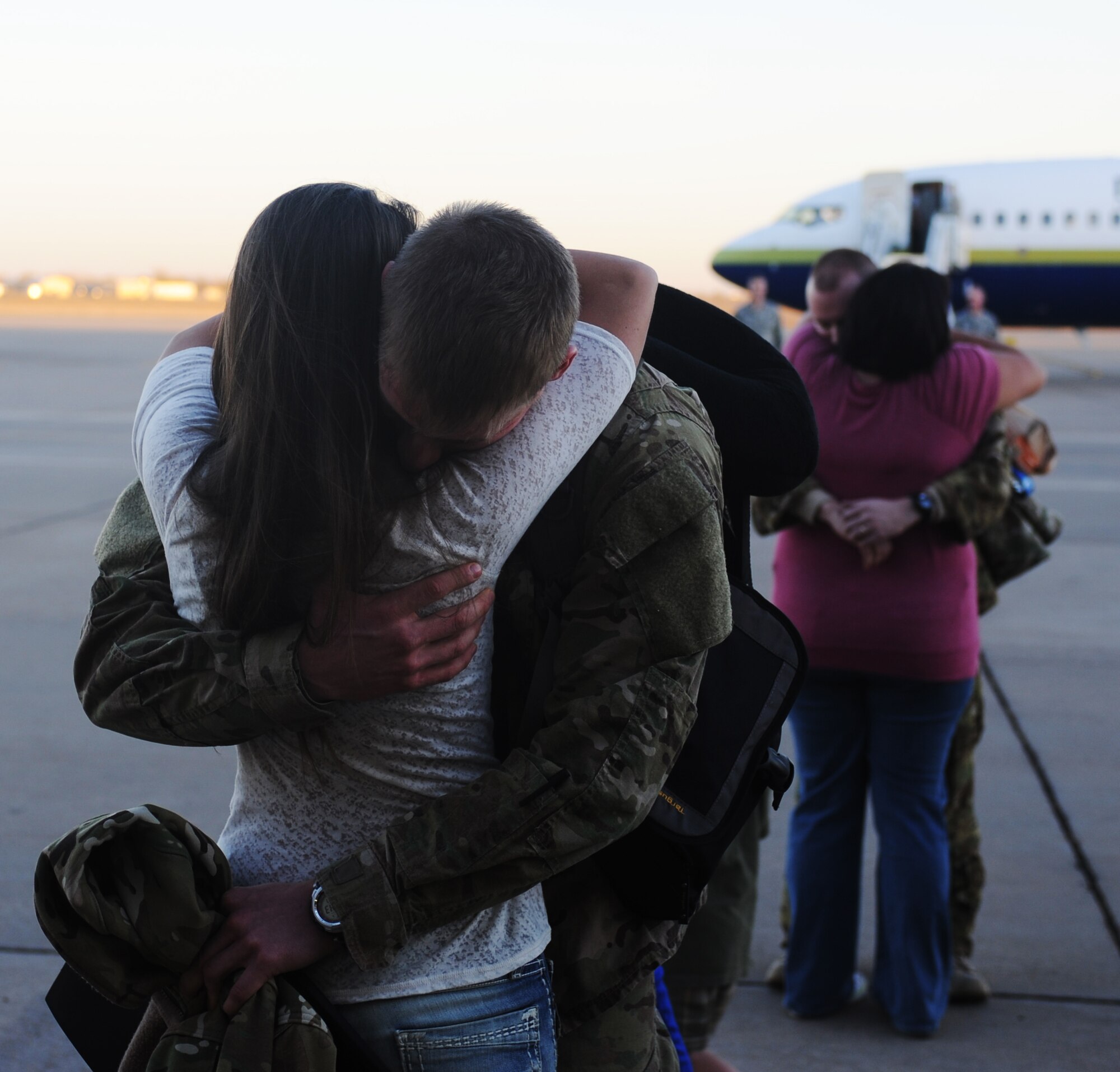A service member hugs his loved one during Operation Homecoming at Cannon Air Force Base, N.M., Nov. 6, 2012. Operation Homecoming is a monthly event held to welcome Air Commandos back from worldwide deployments and reunite them with family and friends. (U.S. Air Force photo/Airman 1st Class Xavier Lockley)
