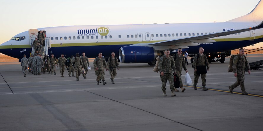 Service members walk off a plane to greet loved ones during Operation Homecoming at Cannon Air Force Base, N.M., Nov.6, 2012. Operation Homecoming is a monthly event held to welcome Air Commandos back from worldwide deployments and reunite them with family and friends. (U.S. Air Force photo/Airman 1st Class Xavier Lockley)