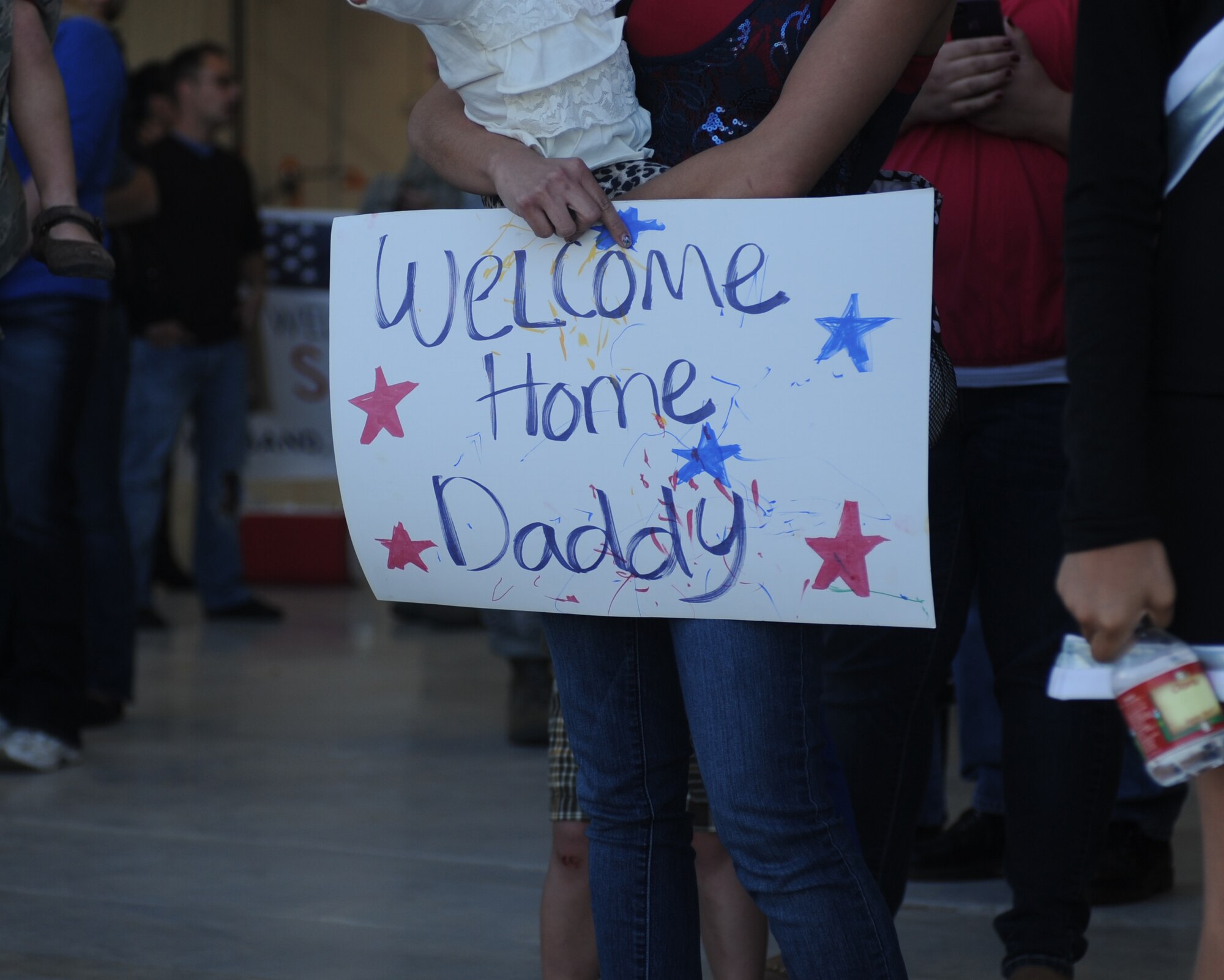 Family members await the arrival of their loved ones during Operation Homecoming at Cannon Air Force Base, N.M., Nov. 6, 2012. Operation Homecoming is a monthly event held to welcome Air Commandos back from worldwide deployments and reunite them with family and friends. (U.S. Air Force photo/Airman 1st Class Xavier Lockley) 