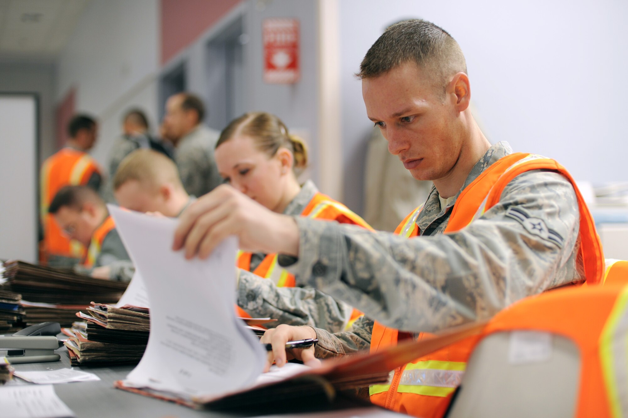 U.S. Air Force Airman 1st Class James Porter, 354th Force Support Squadron career development apprentice, processes deployment folders during an operational readiness exercise Nov. 5, 2012, Eielson Air Force Base, Alaska.  Deployment folders are verified to ensure training and qualification requirements are met prior to an Airman’s departure to a deployed location. (U.S. Air Force photo/Staff Sgt. Jim Araos)