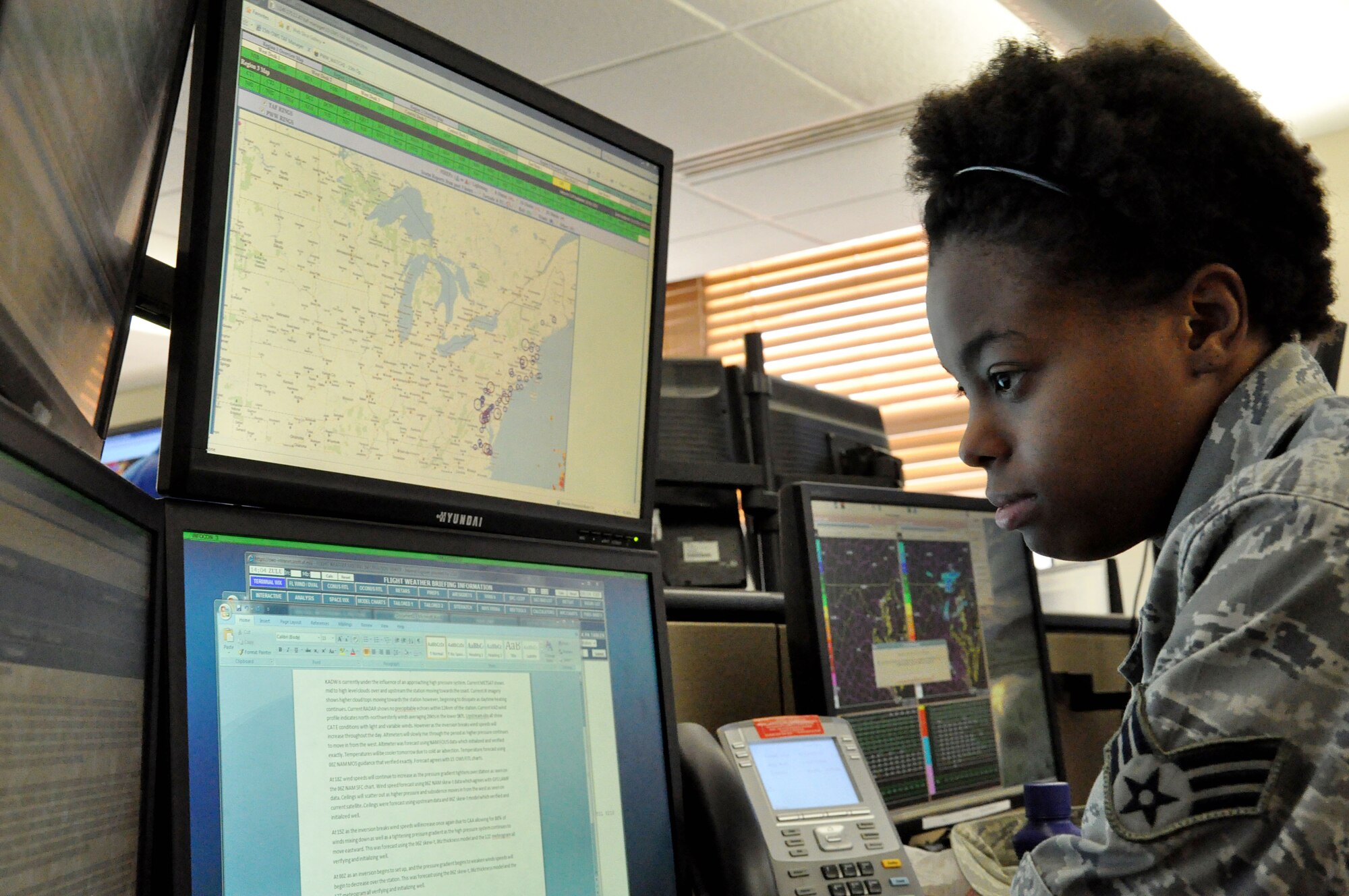 Senior Airman Brittney Ervin, 15 Operational Weather Squadron forecaster, reads reports current weather conditions Nov. 2 at Scott Air Force Base, Ill. The 15th OWS is in charge of all the resource protection and forecasting for the northeast Unites States from the northern plains, the Midwest and half of the Atlantic coast, from Virginia north. They provide 150 locations in that area with warnings and guidance. (U.S. Air Force photo/Airman 1st Class Jake Eckhardt)