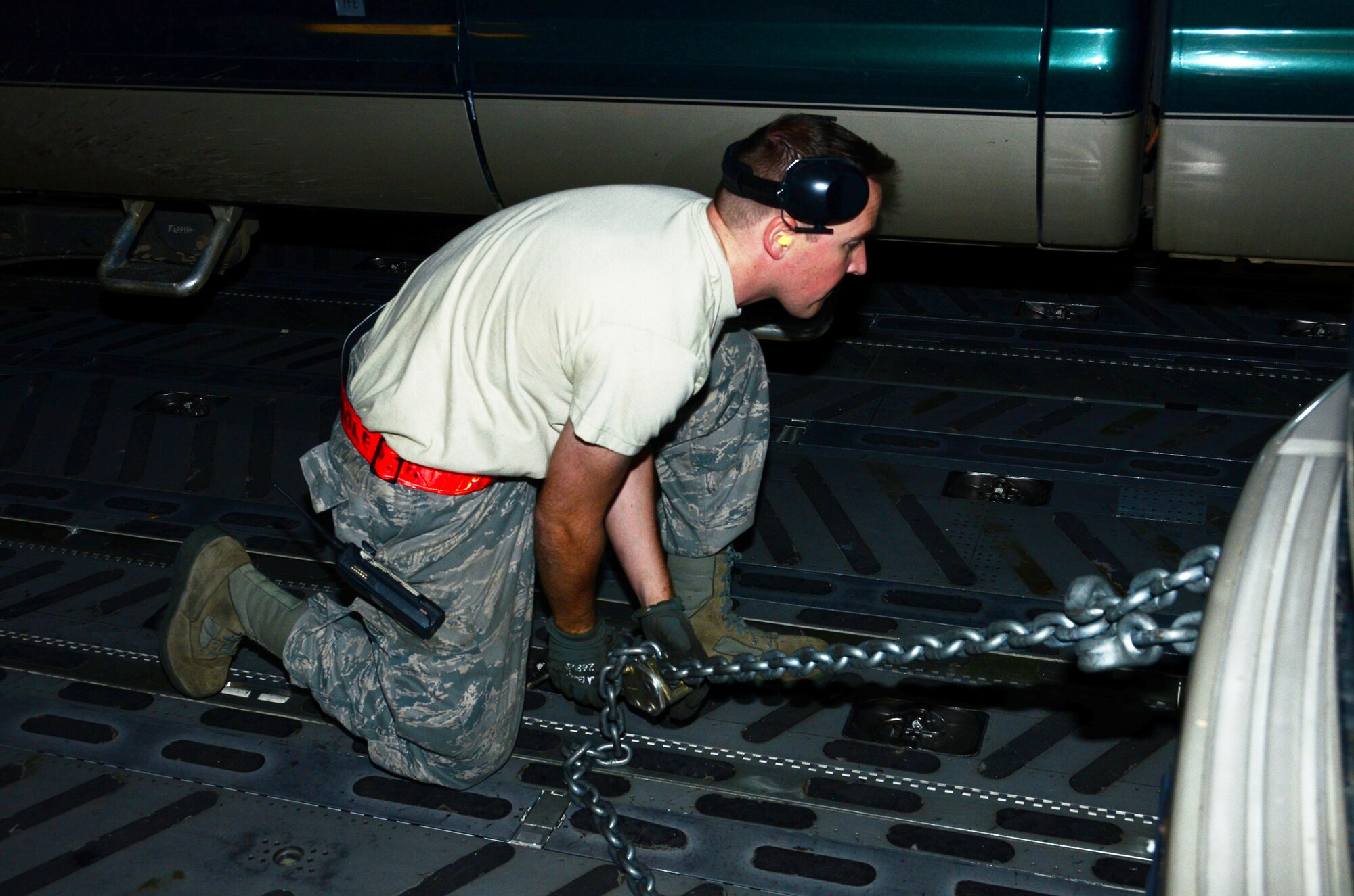 An Airman secures one of four heavy-duty trucks inside a 445th Airlift Wing C-17 Globemaster III cargo aircraft at Joint Base Lewis-McChord AFB, Wash. Nov. 6.  Members of the 445th transported cargo from Joint Base Lewis-McChord to Joint Base McGuire-Dix-Lakehurst, N.J. Nov. 6 and 7 in support of disaster relief efforts in the wake of Hurricane Sandy. (U.S. Air Force Photo/Capt. John Stamm)