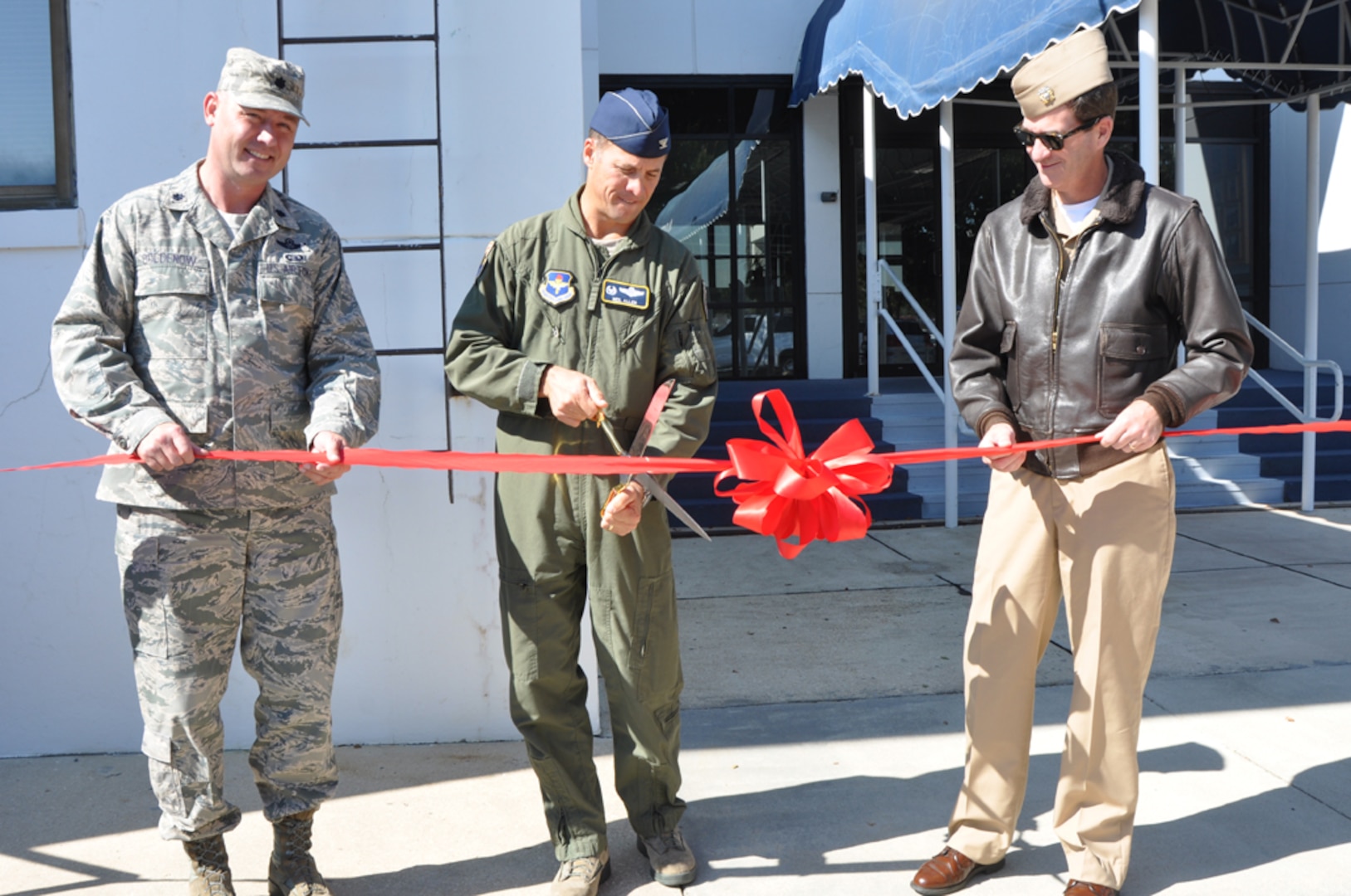 Lt. Col. Justin Boldenow, 479th Operations Support Squadron commander, Col. Neil Allen, 479th Flying Training Group commander, and Navy Capt. Christopher  Plummer, Naval Air Station Pensacola commander, cut the ribbon for the 479th OSS' Pensacola Regional Communications Facility, Oct. 31 at Naval Air Station Pensacola, Fla.  The 3,400 square-foot facility houses a 23-person communications team that provides a full spectrum of services to all Air Force members in the Pensacola region to include Naval Air Stations Pensacola, Corry Station, and Whiting Field.  (U.S. Navy photo by Janet Thomas)