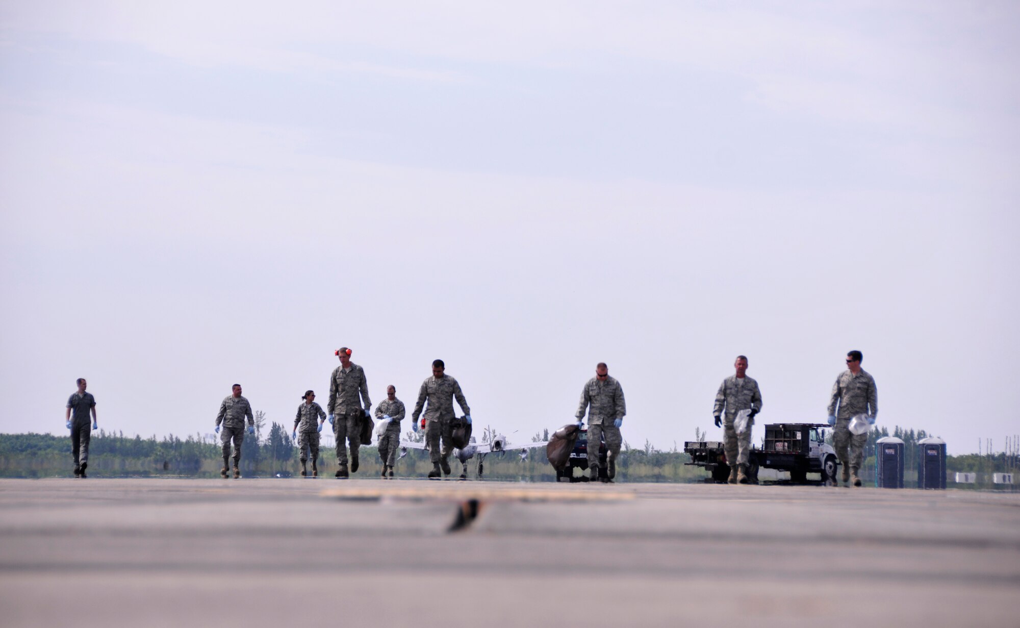 Airmen from Homestead Air Reserve Base conduct a foreign object damage walk on the flightline area of Homestead ARB after the Wings Over Homestead air show, Nov. 5. (U.S. Air Force photo/Senior Airman Jacob Jimenez)