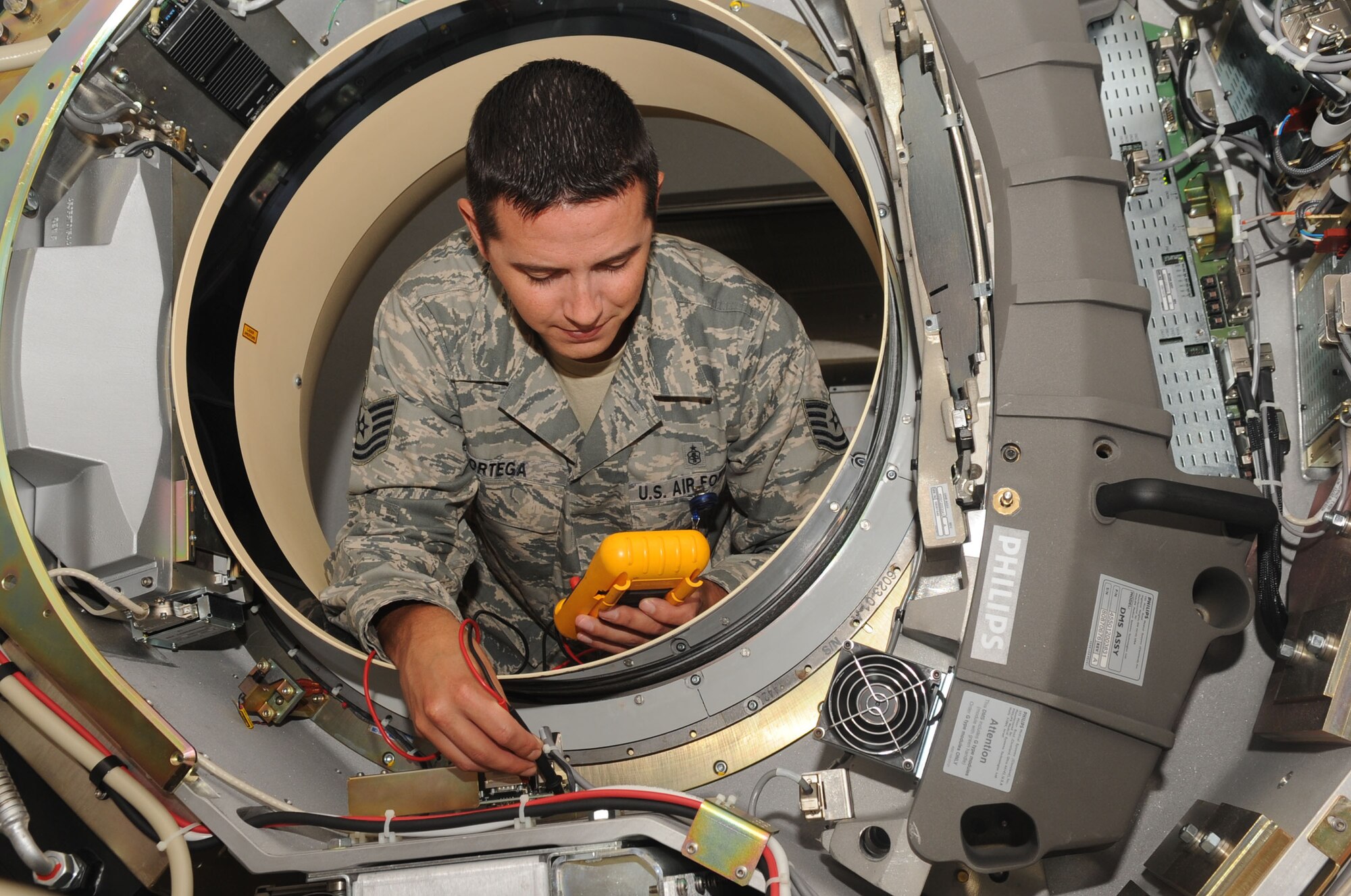 Tech. Sgt. Orlando Ortega, 2nd Medical Support Squadron biomedical equipment maintenance technician, uses a digital multimeter on a computed tomography machine on Barksdale Air Force Base, La., Oct. 25. A multimeter is used to take voltage measurements to determine what needs to be fixed on broken equipment. (U.S. Air Force photo/Senior Airman Kristin High)(RELEASED)
