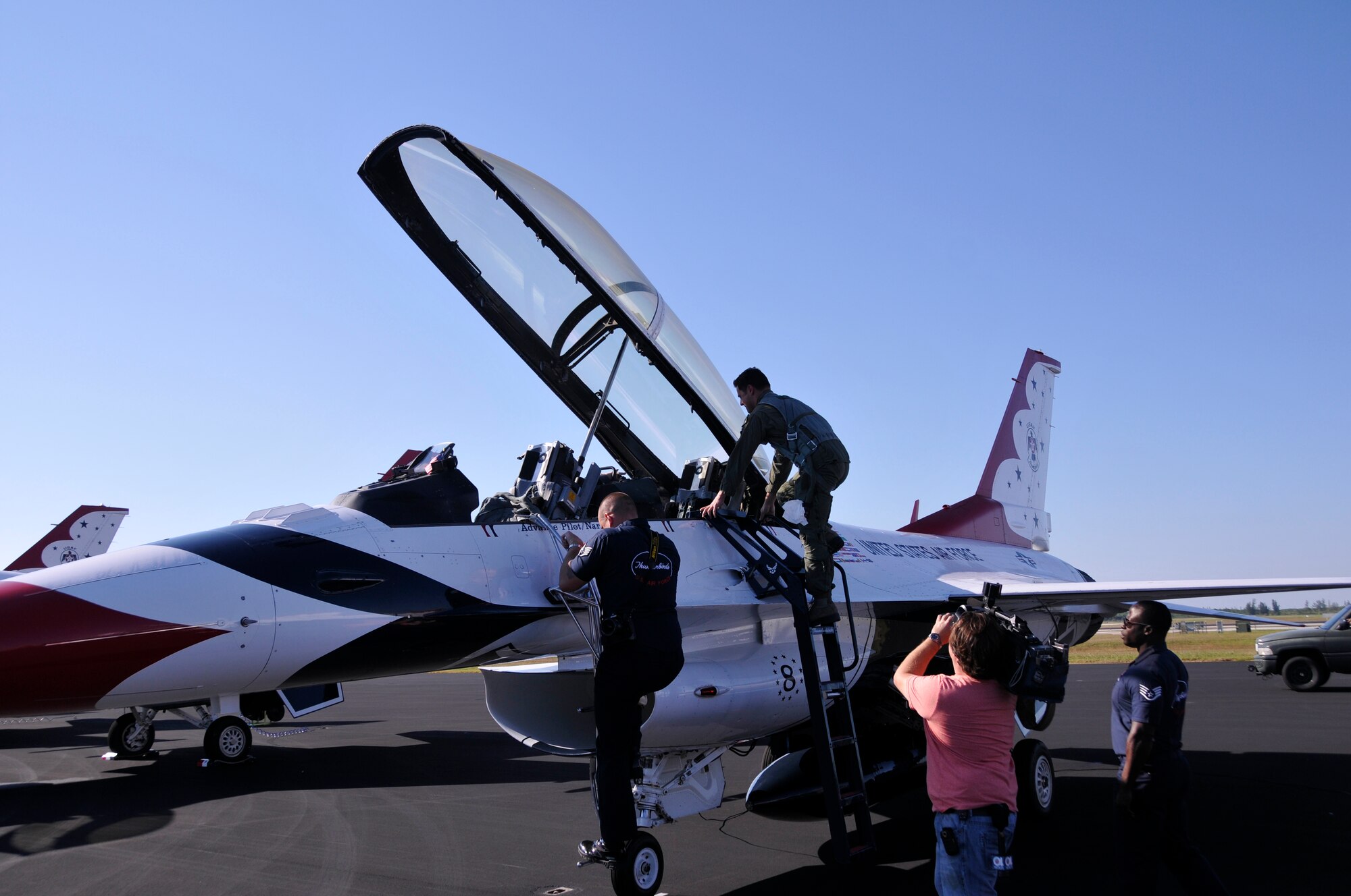 Scott Padgett, Local 10 news meteorologist, climbs aboard a U.S. Air Force Thunderbird F-16 to take a flight during a practice run, Nov.1, for the Wings Over Homestead air show at Homestead Air Reserve Base, Fla. (U.S. Air Force photo/Staff Sgt. Lou Burton)