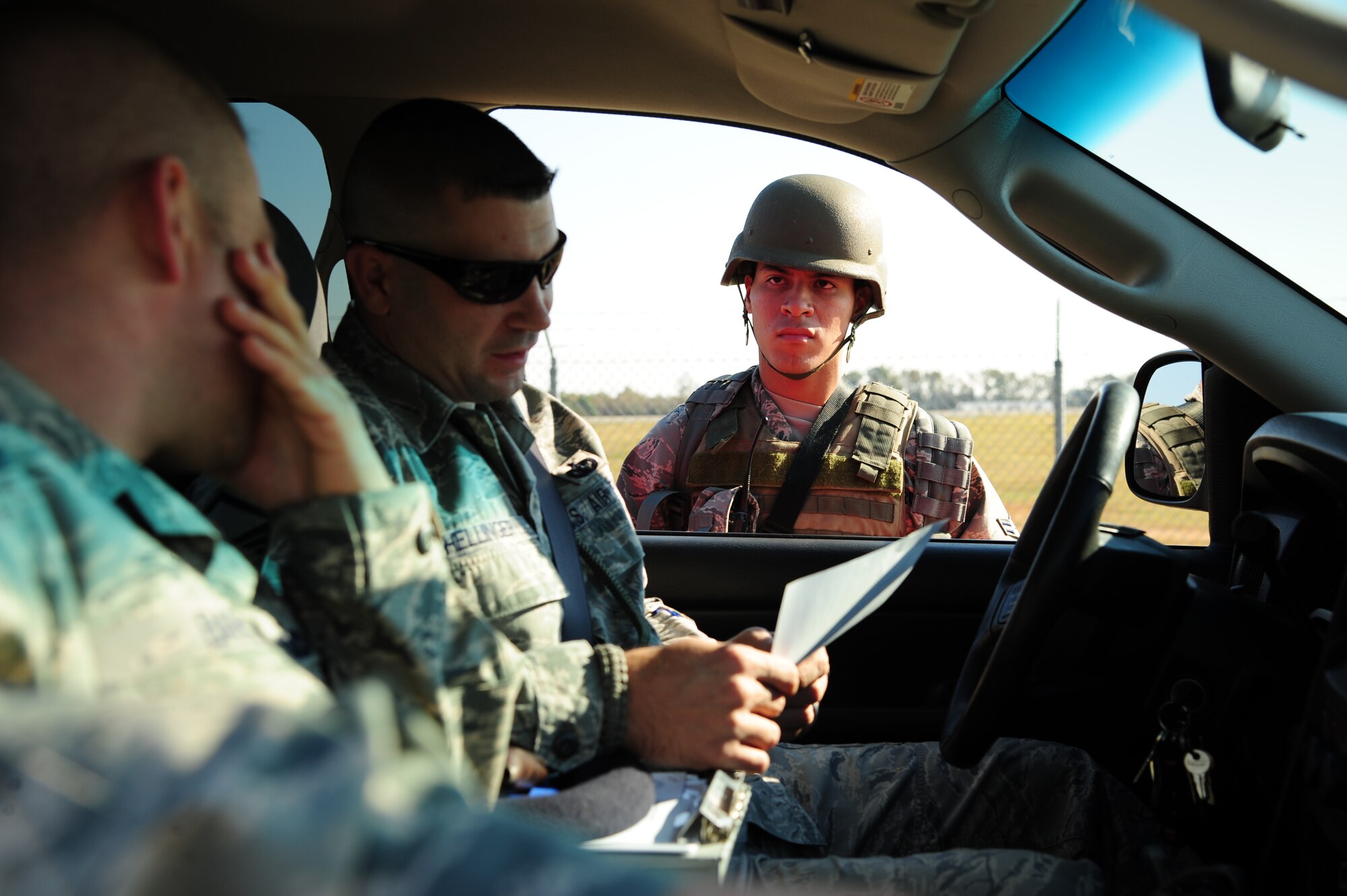 U.S. Air Force Master Sgt. Scott Hellinger, 4th Fighter Wing anti-terrorism officer, and Airman 1st Class Jose Lurita-Sanchez, 4th Security Forces Squadron augmentee, discuss current force protection condition measures during Operational Readiness Exercise Coronet Warrior 12-05 on Seymour Johnson Air Force Base, N.C., Nov. 5, 2012. Lurita-Sanchez’s duties and responsibilities are to secure the area by conducting 100 percent, hands-on identification checks of all personnel entering the area. (U.S. Air Force photo/Tech. Sgt. Colette M. Graham/Released)