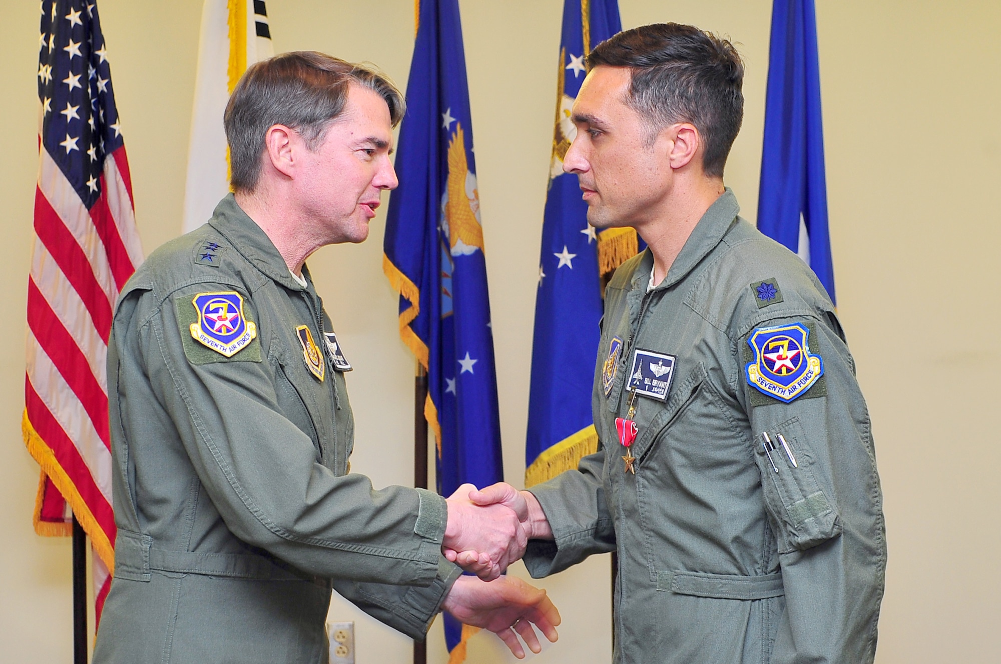 Lt. Col. William Bryant, 7th Air Force plans and strategy deputy director, shakes hands with Lt. Gen. Jan-Marc Jouas, 7th Air Force commander, following the presentation of the Bronze Star Medal after his year-long deployment to Ali Air Base, Iraq, in a ceremony at the Osan Officer's Club Oct. 26, 2012. The Bronze Star Medal is awarded to personnel in any branch of the military service who distinguished themselves by heroic or meritorious achievement or service in connection with military operations against an armed enemy. (U.S. Air Force photo/Tech. Sgt. Raymond Mills)