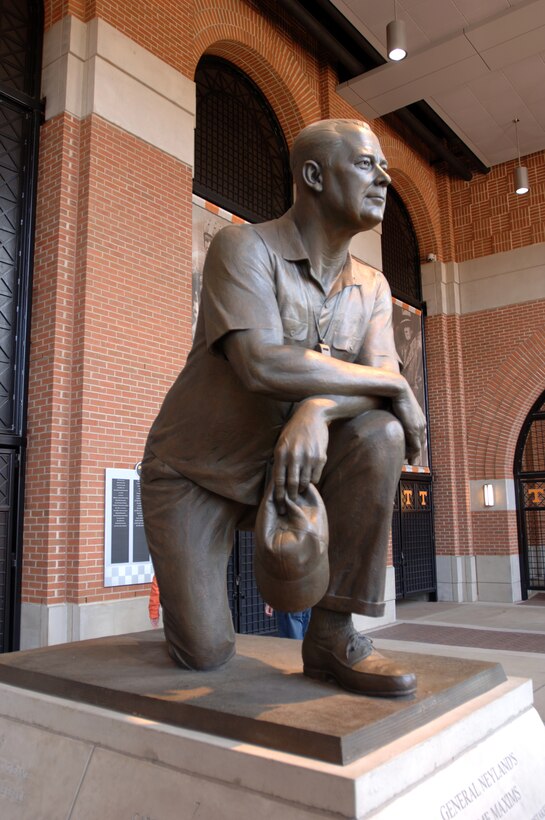 This statue honors Brig. Gen. Robert R. Neyland, who served as commander and district engineer of the Nashville and Chattanooga Districts in 1933 and 1934, while simultaneously teaching military science and coaching the Volunteers. While in the Corps of Engineers, Neyland is known for working and doing paperwork in the backseat of his car while en route between his various duties and his coaching hobby. He served three stints as the head football coach (1926–1934, 1936–1940, 1946–1952). Neyland holds the record for most wins in Tennessee Volunteers history with 173 wins in 216 games, six undefeated seasons, nine undefeated regular seasons, seven conference championships, and four national championships. His '39 squad is the last NCAA team in history to hold every regular season opponent scoreless. This photo is taken on Military Appreciation Day Nov. 3, 2012 at the Volunteers' game versus the Troy Trojans. (USACE photo by Leon Roberts)