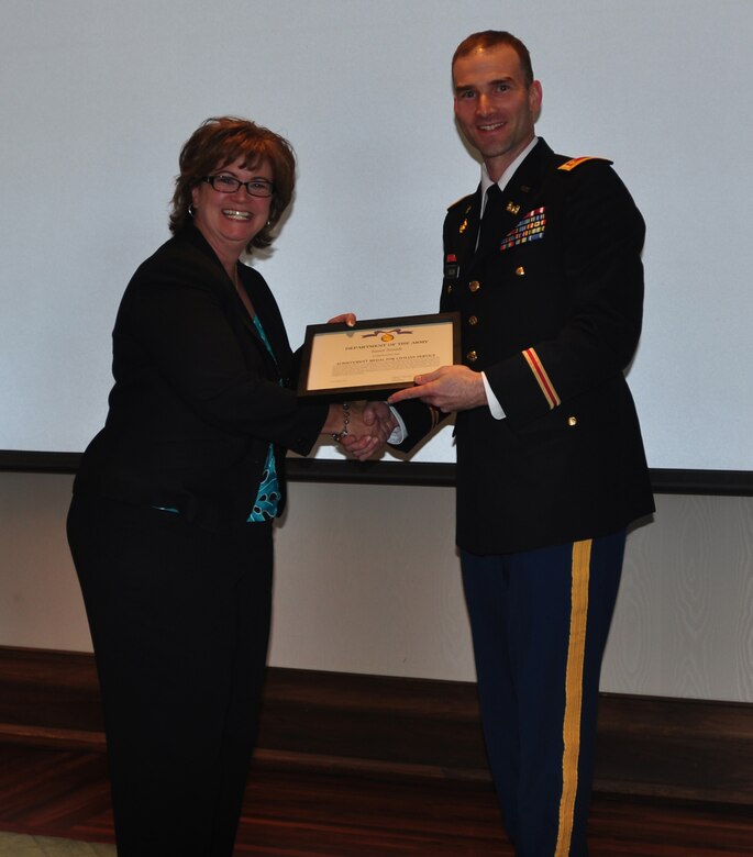 Maj. Patrick Dagon, deputy commander for the Nashville District, presents Janet Smith, secretary to the commander, a Department of the Army Achievement Medal for Civilian Service for her efforts as the assistant coordinator for the 2012 EAGLE Class during the Nashville District's 2012 EAGLE Class graduation held on Thursday, Nov. 1, 2012 at the Jack C. Massey Business Center at Belmont University. (USACE photo by Amy Redmond)