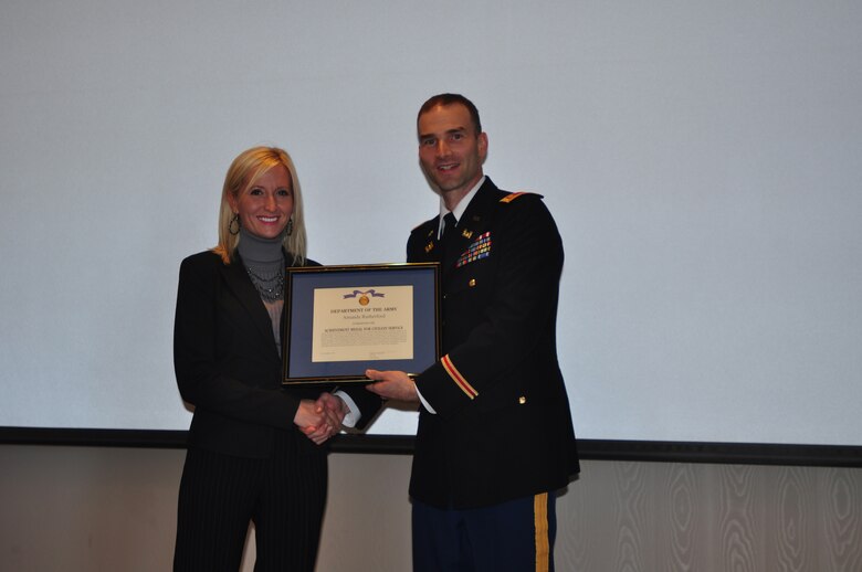 Maj. Patrick Dagon, deputy commander for the Nashville District, presents Amanda Rutherford, accountant, a Department of the Army Achievement Medal for Civilian Service for her efforts as the coordinator for the 2012 EAGLE Class during the Nashville District's 2012 EAGLE Class graduation held on Thursday, Nov. 1, 2012 at the Jack C. Massey Business Center at Belmont University. (USACE photo by Amy Redmond)