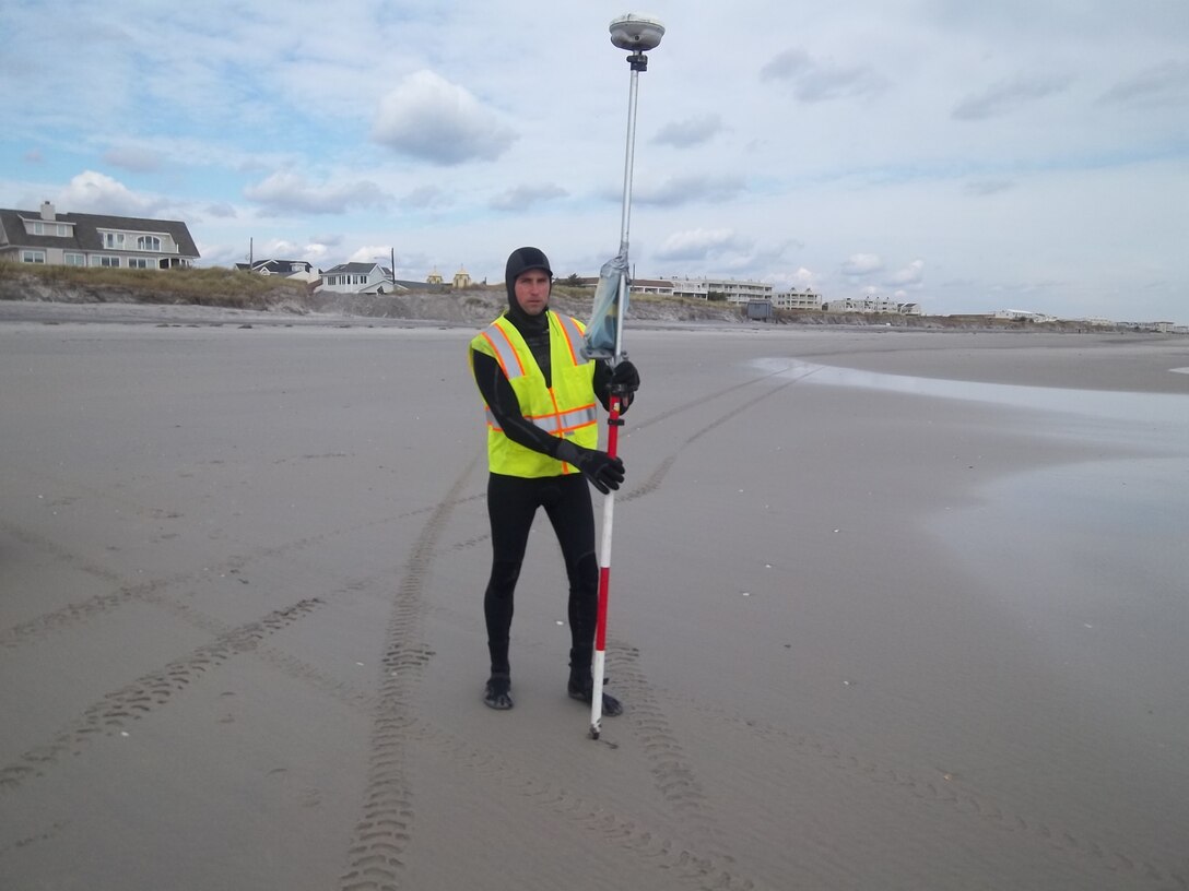 Matt Tuttle, a survey technician from the U.S. Army Corps of Engineers Philadelphia District, uses GPS and survey equipment to measure impacts to beach nourishment projects along the NJ coast. Teams are collecting data to measure the impact of historic Hurricane Sandy.  
