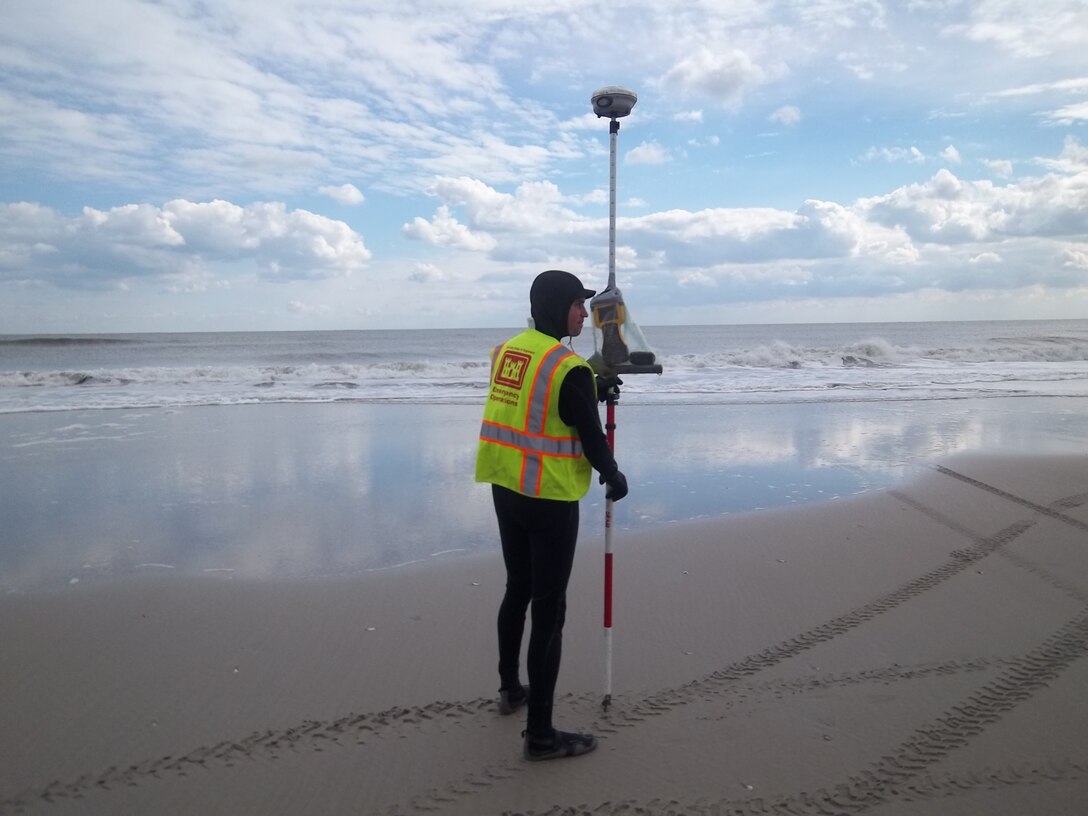 Matt Tuttle, a survey technician from the U.S. Army Corps of Engineers Philadelphia District, uses GPS and survey equipment to measure impacts to beach nourishment projects along the NJ coast. Teams are collecting data to measure the impact of historic Hurricane Sandy.  