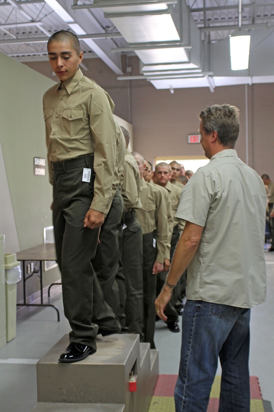 Recruits of Company L, 3rd Recruit Training Battalion, are inspected for any necessary tailoring needs to their dress uniforms aboard Marine Corps Recruit Depot San Diego, Oct. 31. Uniform fitting is a milestone for recruits that signifies they are very close to graduation. 