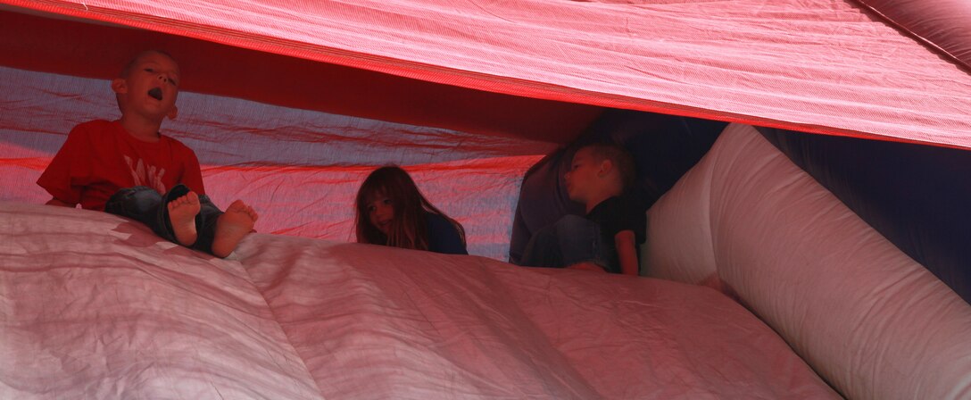 Children play on an inflatable slide at the Headquarters and Service Companies, Combat Logistics Regiment 17, 1st Marine Logistics 
Group, family fun day, at Camp Pendleton, Calif., Nov. 2. The event included a three-mile hike, rappelling and spouses firing weapons at the indoor simulated marksmanship trainer.