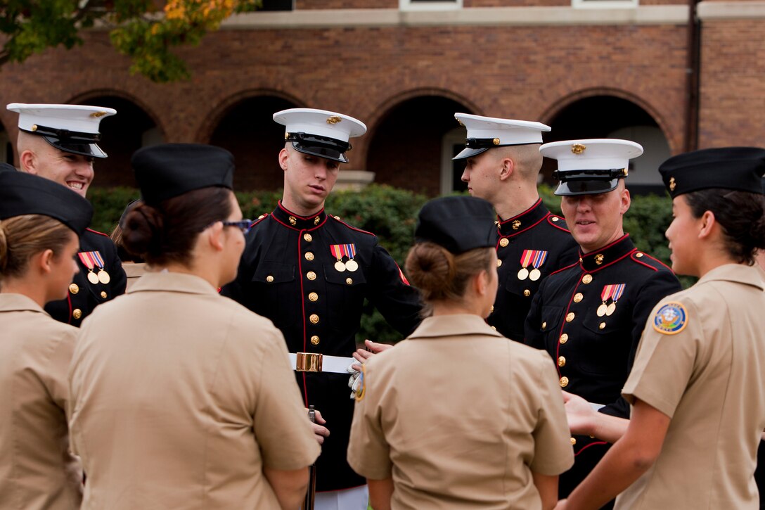 Marine Corps Silent Drill Platoon members speak with high school cadets after a special performance for the Sgt. Eugene Ashley High School's Navy JROTC cadets at the Marine Barracks Washington Oct. 26. 