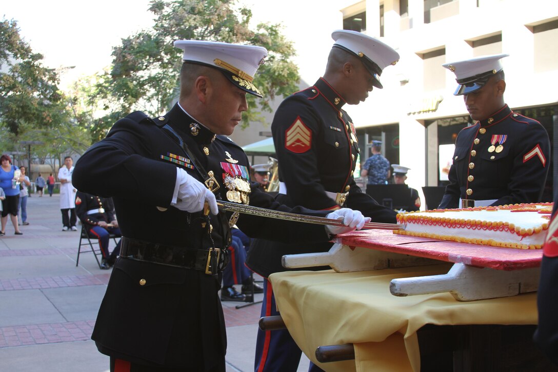 Brig. Gen. Daniel D. Yoo, commanding general, Marine Corps Recruit Depot San Diego and Western Recruiting Region, cuts the first piece of cake to offer to the host at the Cake Cutting Ceremony honoring the Marine Corps’ 237th birthday with the Wounded Warriors aboard Naval Medical Center San Diego Nov. 5.