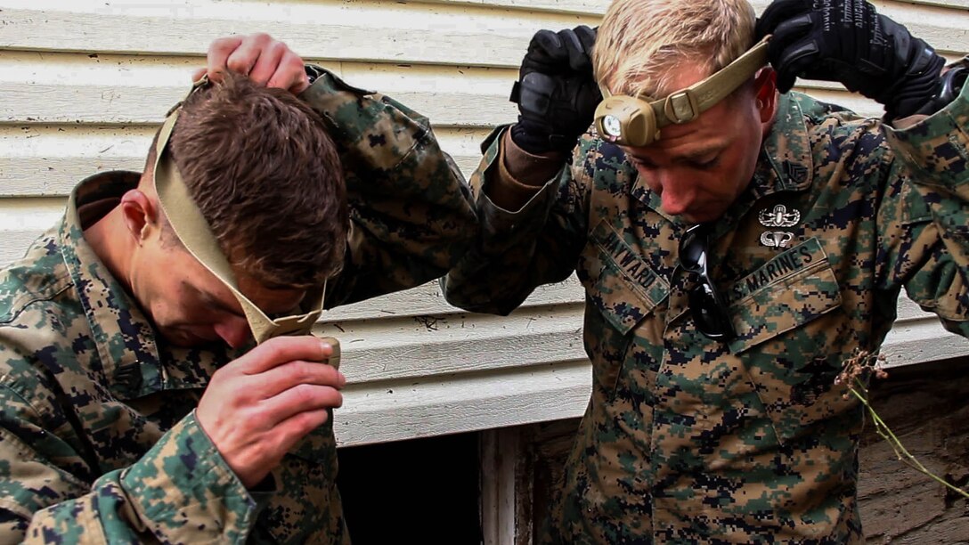 Staff Sgt. James-Lucas Vincent and Sgt. Jason Hayward with Explosive Ordinance disposal, Combat Logistics Battaliion 26, 26th Marine Expeditionary Unit (MEU), prepare to enter a flooded basement in Staten Island, NY, Nov. 6, 2012. The 26th MEU is able to provide generators, fuel, clean water, and helicopter lift capabilities to aid in disaster relief efforts. The 26th MEU was currently conducting pre-deployment training, preparing for their departure in 2013. As an expeditionary force operating from the sea, the MEU is a Marine Air-Ground Task Force capable of conducting amphibious operations, crisis response, and limited contingency operations.(U.S. Marine Corps photo by GySgt. Michael Kropiewnicki/Released)