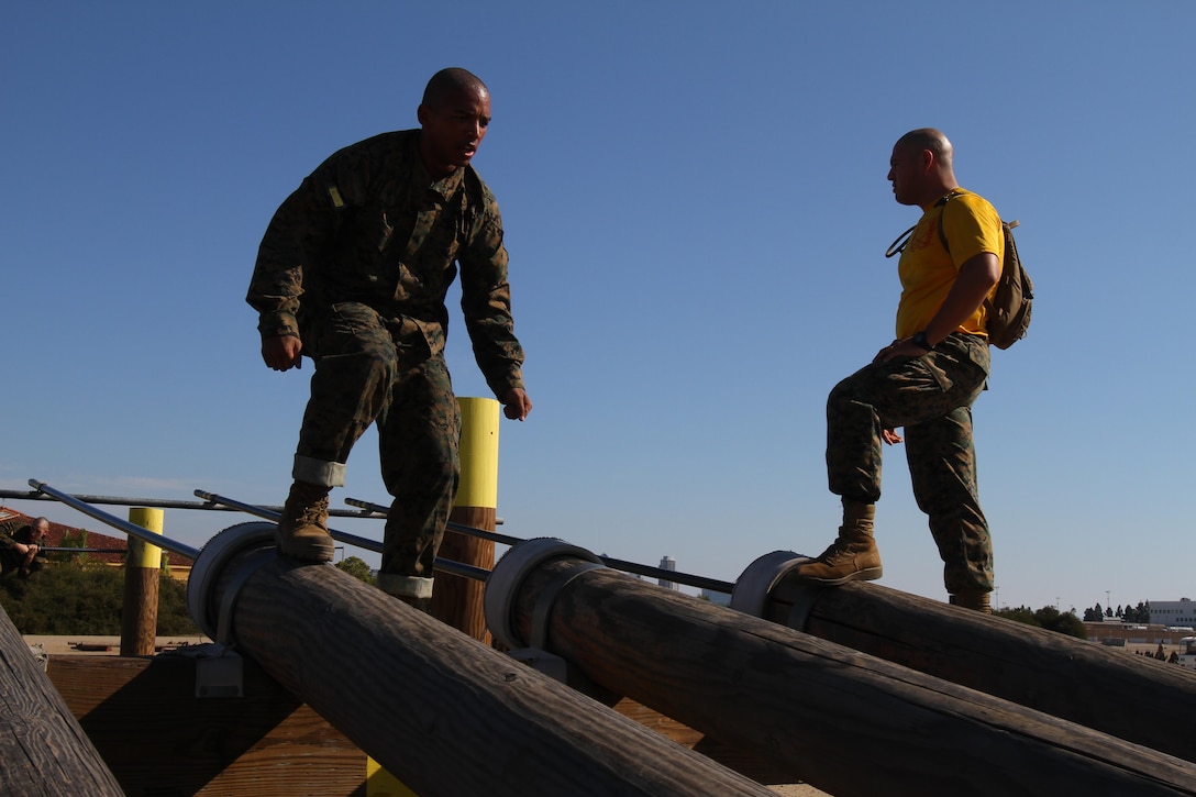 A recruit of Company H, 2nd Recruit Training Battalion, maneuvers down a set of logs during the obstacle course aboard Marine Corps Recruit Depot San Diego Nov. 1.