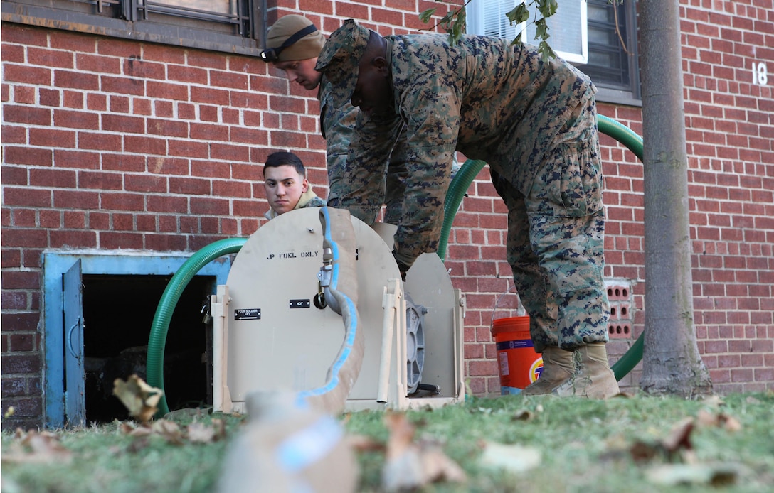 Marines with 8th Engineer Support Battalion, 2nd Marine Logistics Group prepare to start a gas-powered pump to remove water from a flooded basement while conducting humanitarian operations in Far Rockaway, N.Y., Nov. 4. In coordination with United States Northern Command approximately 86 Marines from the unit were deployed to New York to help pump water from flooded areas of the state.