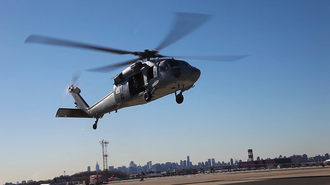 An MH-60S Seahawk flies overhead as Marines assigned to Landing Support Platoon, Combat Logistics Battalion (CLB) 26, 26th Marine Expeditionary Unit (MEU) prepare a generator to be lifted, Nov. 6, 2012, to help the New York and New Jersey Port Authority move the generator from LaGuardia Airport to a damaged pier. The USS Wasp and the 26th MEU are currently off the coast of New York City in support of Hurricane Sandy disaster relief efforts in New York and New Jersey. The 26th MEU is able to provide generators, fuel, clean water, and helicopter lift capabilities to aid in disaster relief efforts. The 26th MEU was currently conducting pre-deployment training, preparing for their departure in 2013. As an expeditionary force operating from the sea, the MEU is a Marine Air-Ground Task Force capable of conducting amphibious operations, crisis response, and limited contingency operations. (U.S. Marine Corps photo by Cpl. Christopher Stone/Released)