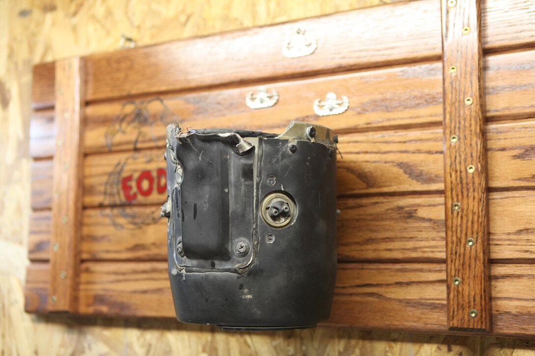 A plaque with the demilitarized guidance system of a Hellfire missile hangs on the wall in the workshop of retired Staff Sgt. Brad M. Lang, who was a technician with 2nd Explosive Ordnance Disposal Company, 2nd Marine Logistics Group, in Jacksonville, N.C., Oct. 26, 2012. Lang’s fellow EOD technicians gave him the guidance system, which was used to engage the enemy on his last mission in Afghanistan, where Lang lost both of his legs to an improvised explosive device.