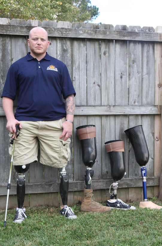 Retired Staff Sgt. Brad M. Lang, who was a technician with 2nd Explosive Ordnance Disposal Company, 2nd Marine Logistics Group, stands next to several of his prosthetic legs in Jacksonville, N.C., Oct. 26, 2012. Lang lost both of his legs when an improvised explosive device detonated in Afghanistan in 2011, and he now owns his own business.