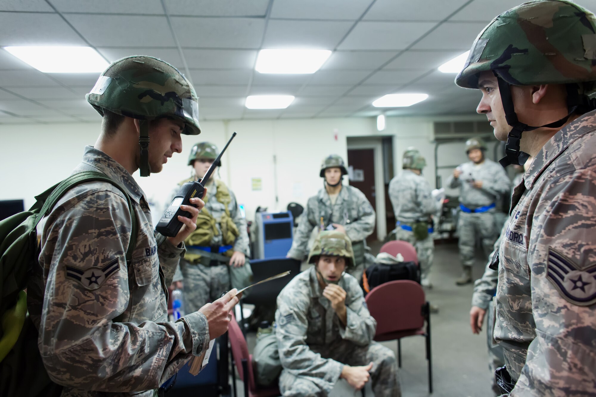 YOKOTA AIR BASE, Japan -- Senior Airman Corey Carter, right, reports a situation to the Unit Control Center during operational readiness exercise at Yokota Air Base, Japan, Nov. 6, 2012. The 374th Airlift Wing exercises and inspections office organizes regularly scheduled exercises to test the capabilities of base personnel to respond to a variety of possible accidents and incidents. (U.S. Air Force photo by Osakabe Yasuo)