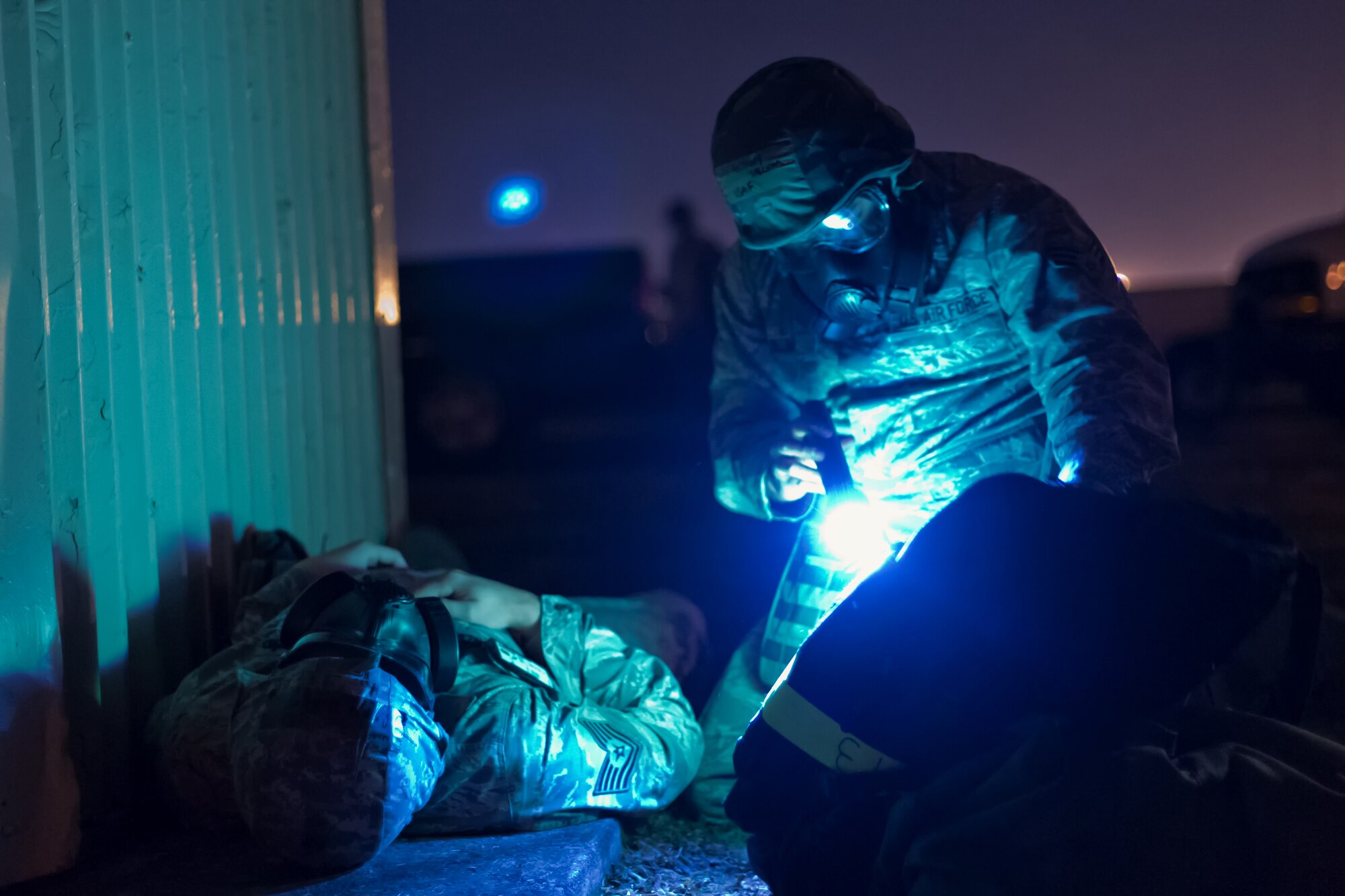 YOKOTA AIR BASE, Japan -- Senior Airman Anthony Yallum, 374th Maintenance Squadron, references his Airman’s manual before performing self-aid and buddy care to a victim with a simulated injury during an operational readiness exercise at Yokota Air Base, Japan, Nov. 7, 2012. Airmen at Yokota participate in exercises to maintain their operational readiness capabilities. (U.S. Air Force photo by Osakabe Yasuo)