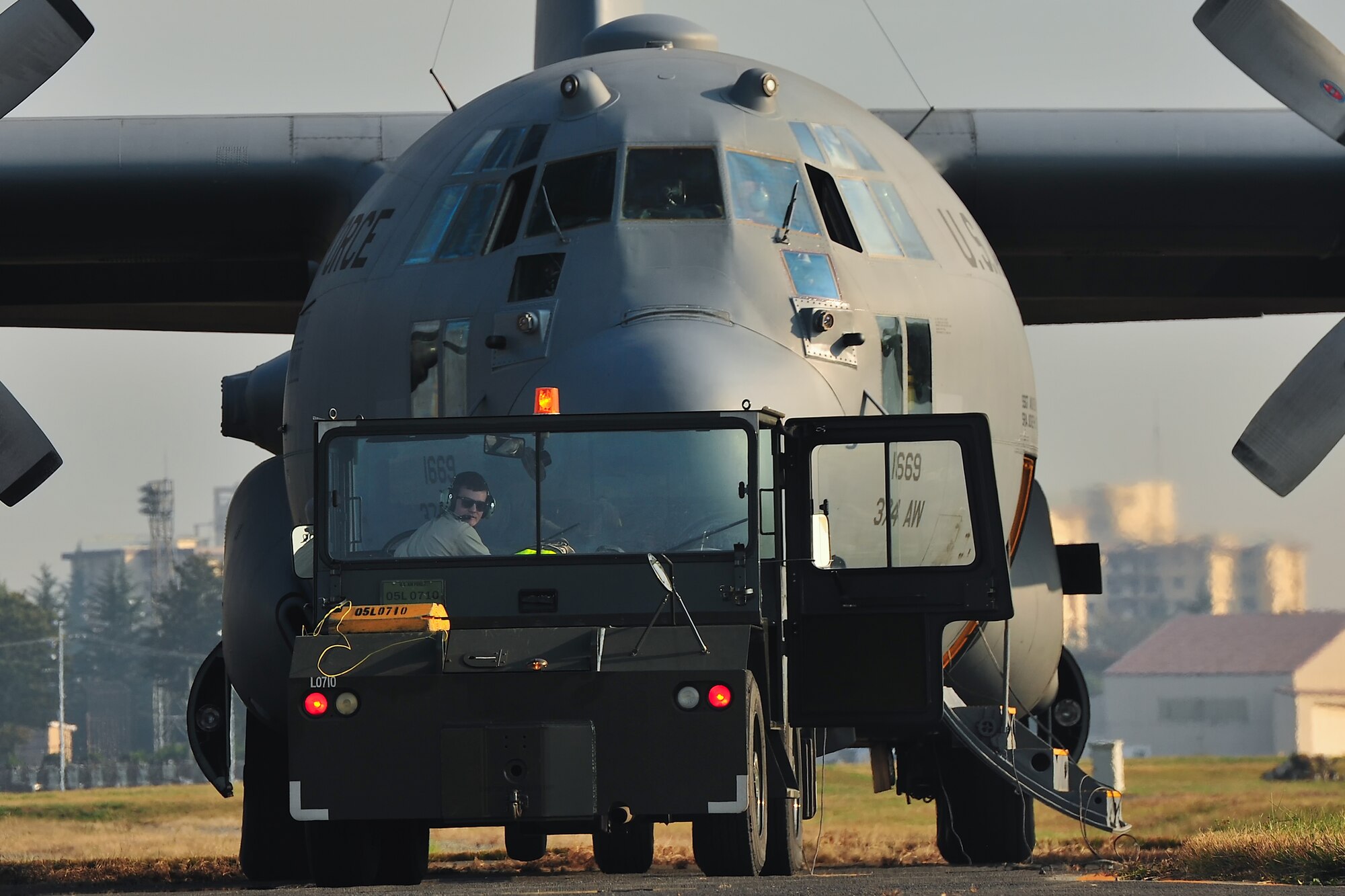 YOKOTA AIR BASE, Japan -- Senior Airman Brandon Hughes, 374th Aircraft Maintenance Squadron crewchief, tows a C-130 Hercules to a parking spot during an operational readiness exercise at Yokota Air Base, Japan, Nov. 5, 2012. Yokota conducted a weeklong operational readiness exercise. (U.S. Air Force photo by Osakabe Yasuo)