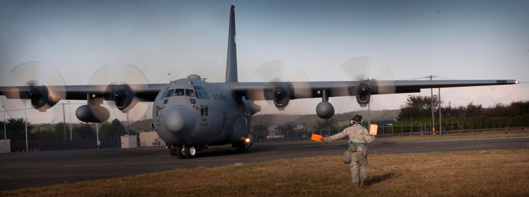 YOKOTA AIR BASE, Japan -- Airman 1st Class Dennis Sharpe, 374th Aircraft Maintenance Squadron crew chief, marshals a C-130 Hercules on Nov. 7, 2012, during an operational readiness exercise at Yokota Air Base, Japan. Yokota participated in a five-day exercise Nov. 5 to 9, 2012. (U.S. Air Force photo by Airman 1st Class Krystal M. Garrett)